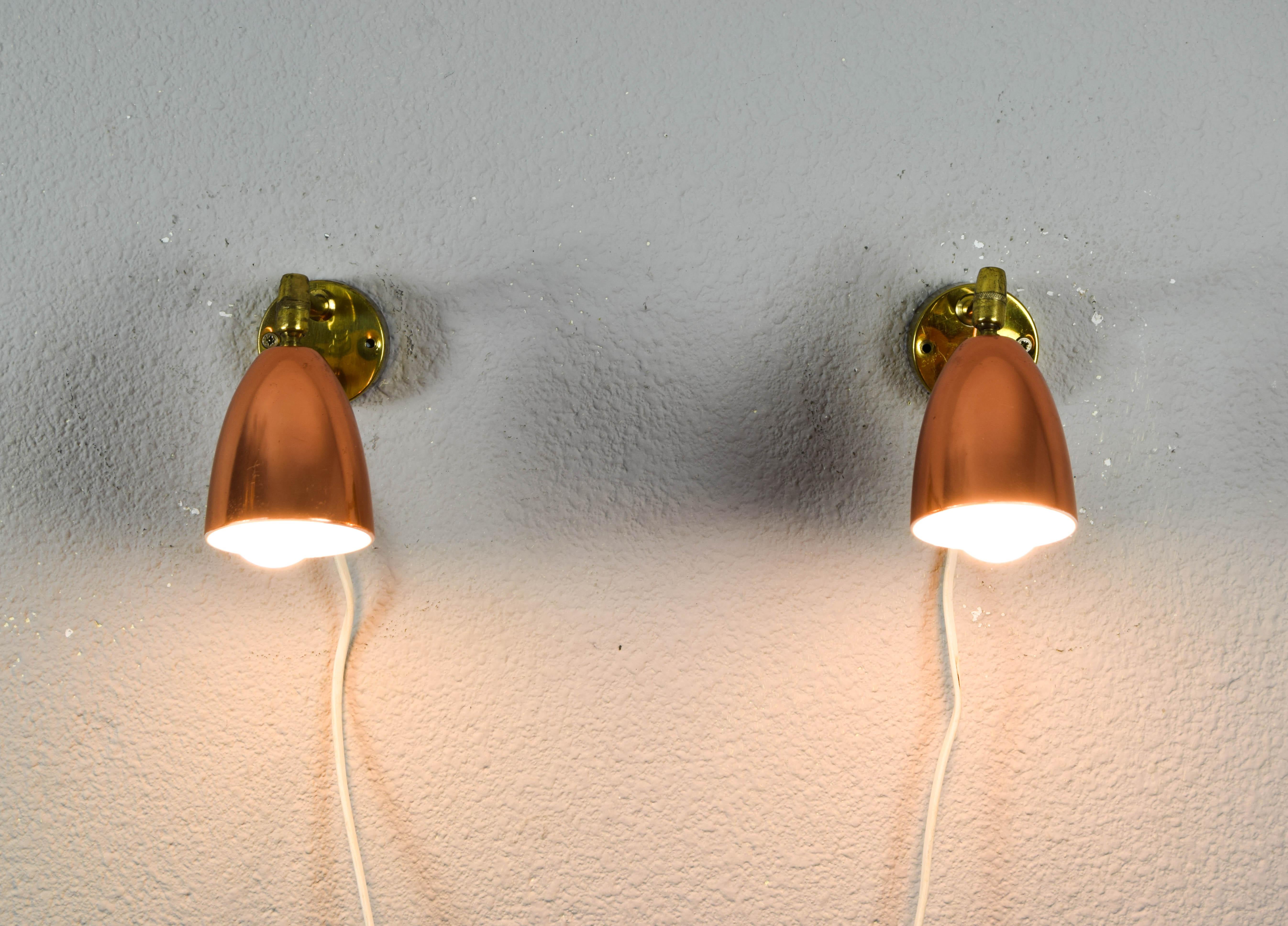 Pair of Jacques Biny style brass and copper wall lights from the 1960s. A refined and simple yet elegant design made of copper and brass with a white painted interior lampshade. Essentially French modernist in its conception and execution. The