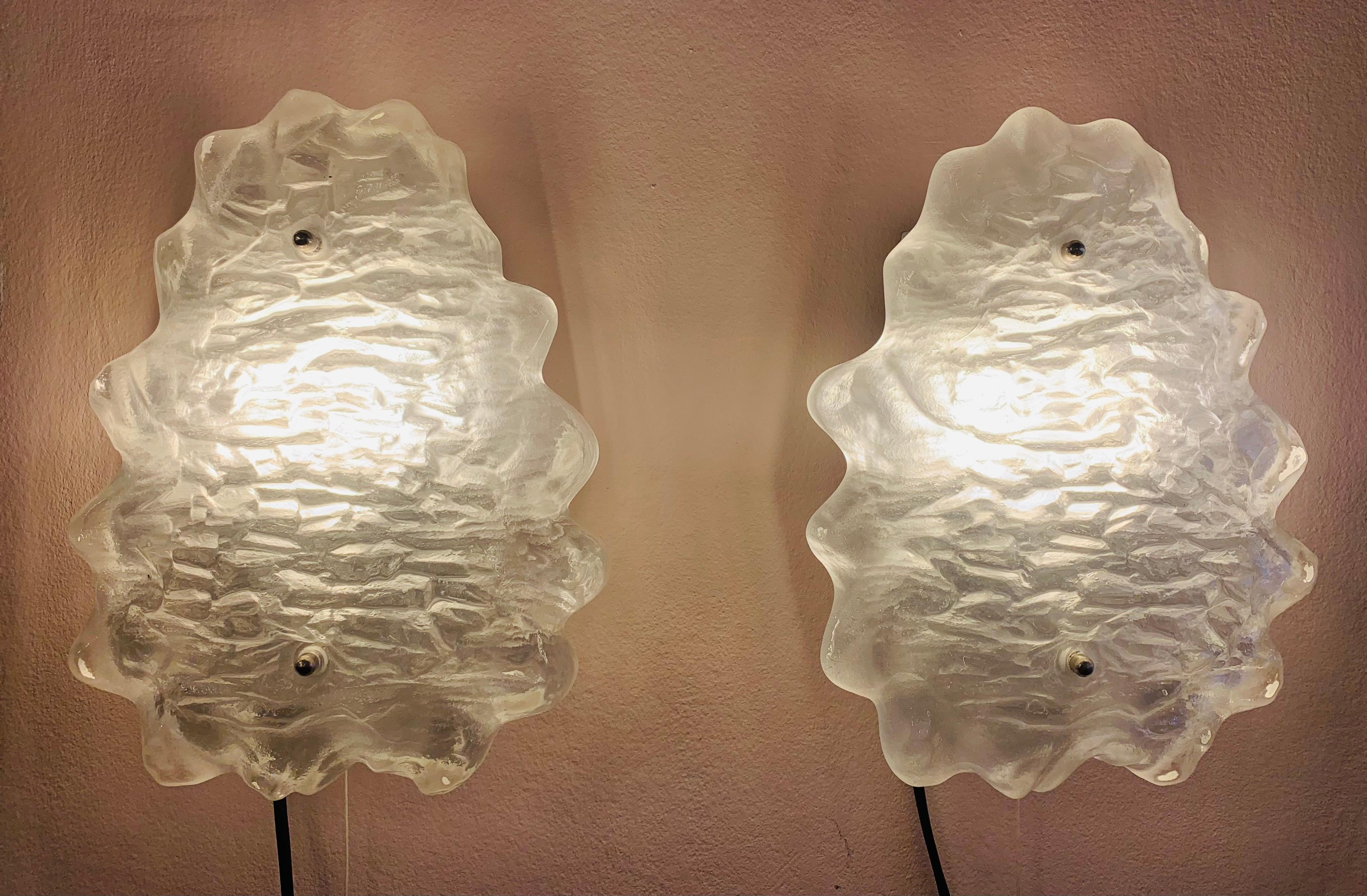 A beautiful pair of 1960s Murano iced or frosted glass wall lights or sconces manufactured by Kalmar Lighting, Austria. Designed by J.T Kalmar. The textured, ripple-effect, frosted, scalloped edged glass shades are held onto the satin nickel
