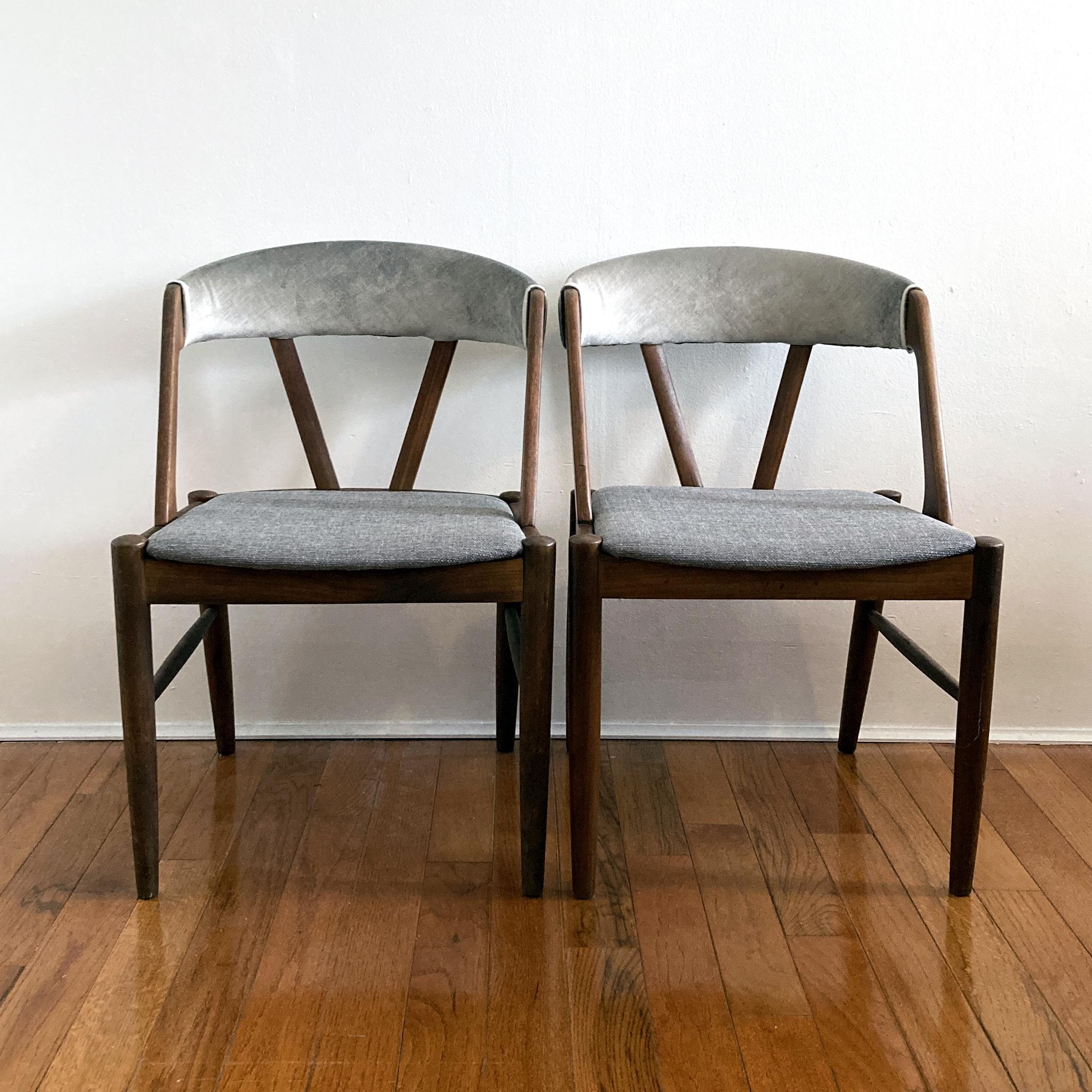 Pair of beautiful midcentury chairs in the style of Kai Kristiansen’s iconic Model 31 chair. Teak frame, new foam padding and reupholstered with grey tweed on the seat and grey velvet at the curved back. Great as side chairs or dining chairs.