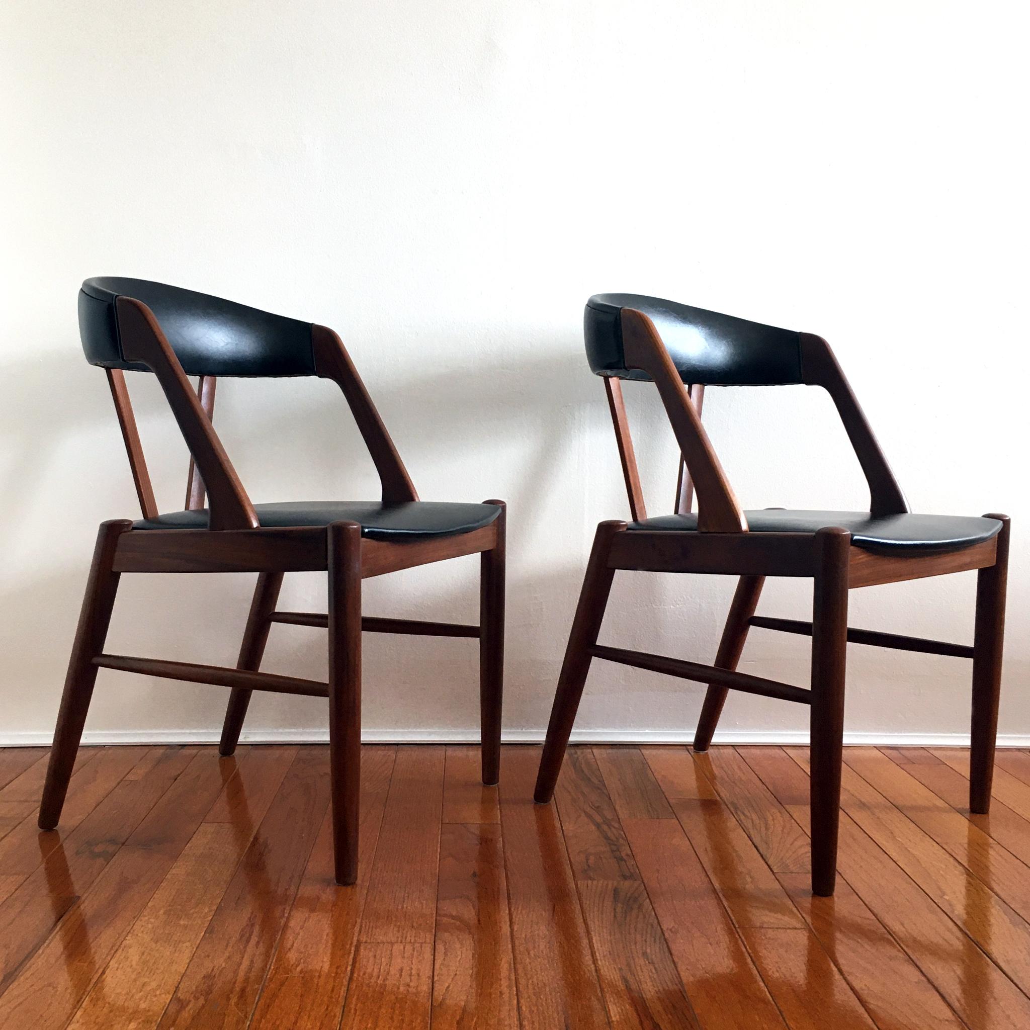 Pair of beautiful midcentury chairs in the style of Kai Kristiansen’s iconic Model 31 chair. Teak frame, with black faux leather seat and chair back.