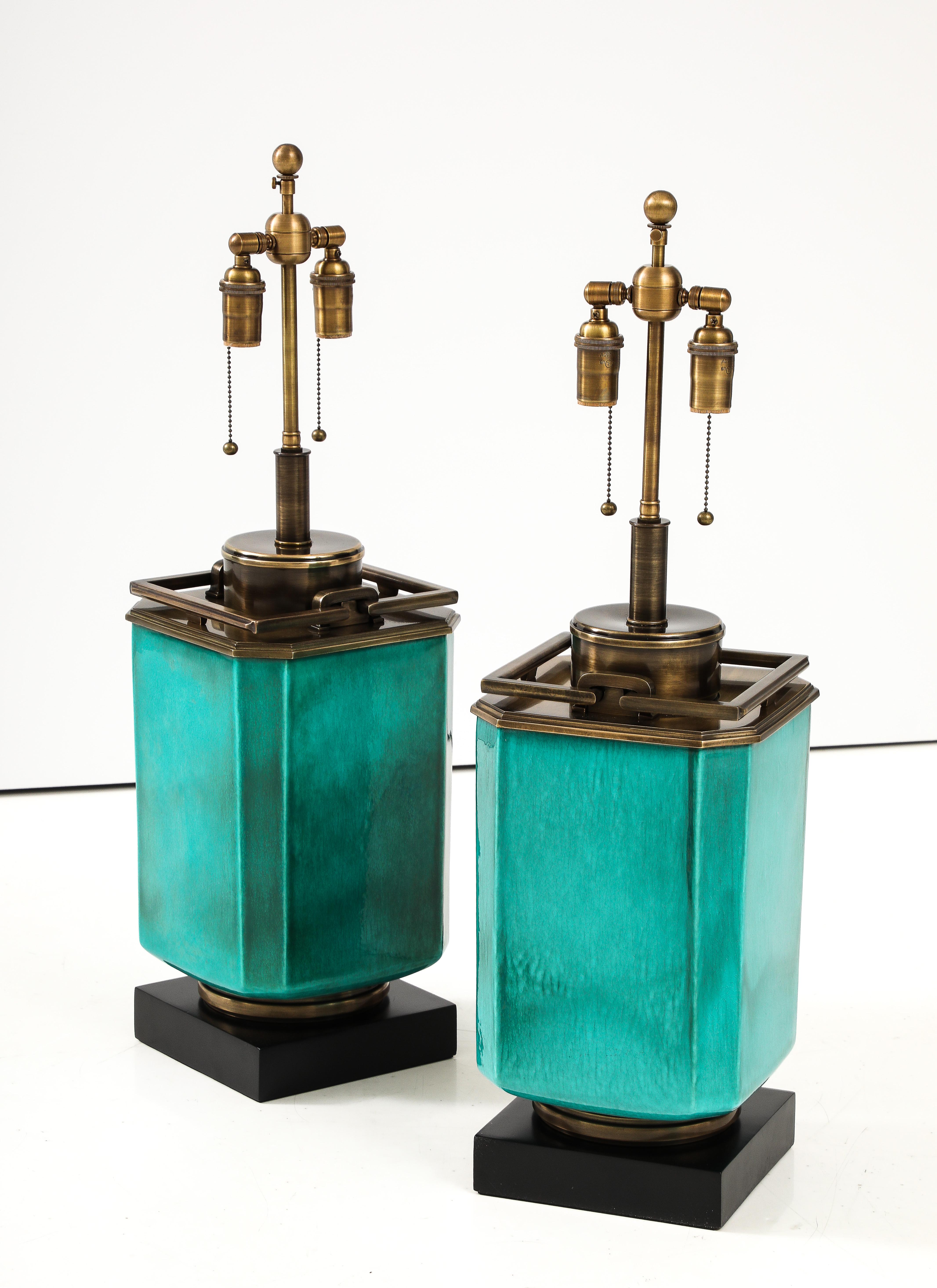 Wonderful large pair of ceramic lamps by Stiffel lamp company.
The lamp bodies have a beautiful Jade green glaze finish and are Mounted on black finished bases with Antiqued bronzed finished appointments.
The lamps have beee Newly rewired with