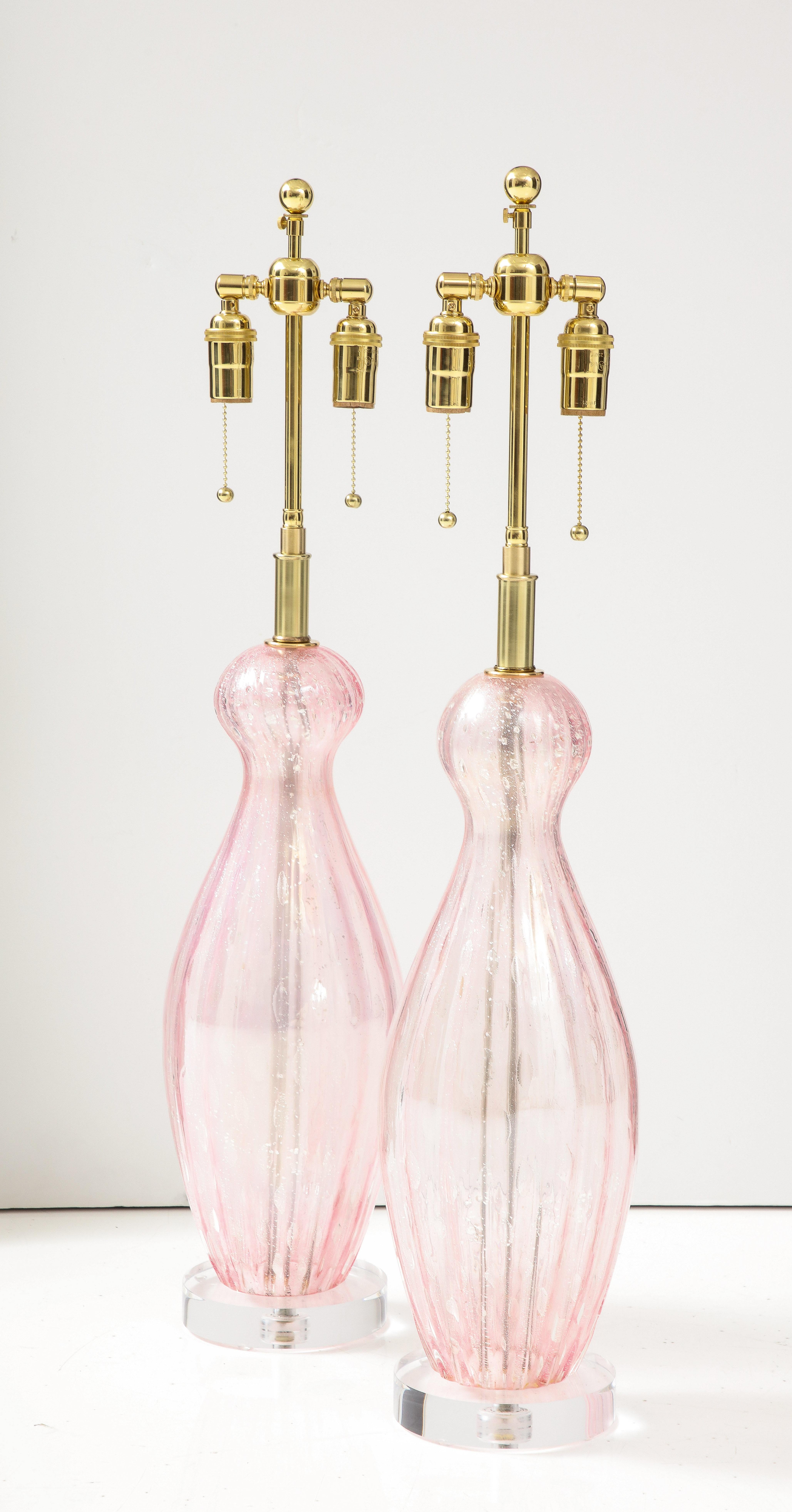 Pair of Large Pink Murano glass lamps with controlled bubbles.
The lamps are mounted on thick lucite bases and have been Newly rewired
with adjustable polished brass double clusters that take standard size light
bulbs.
The height to the top of the