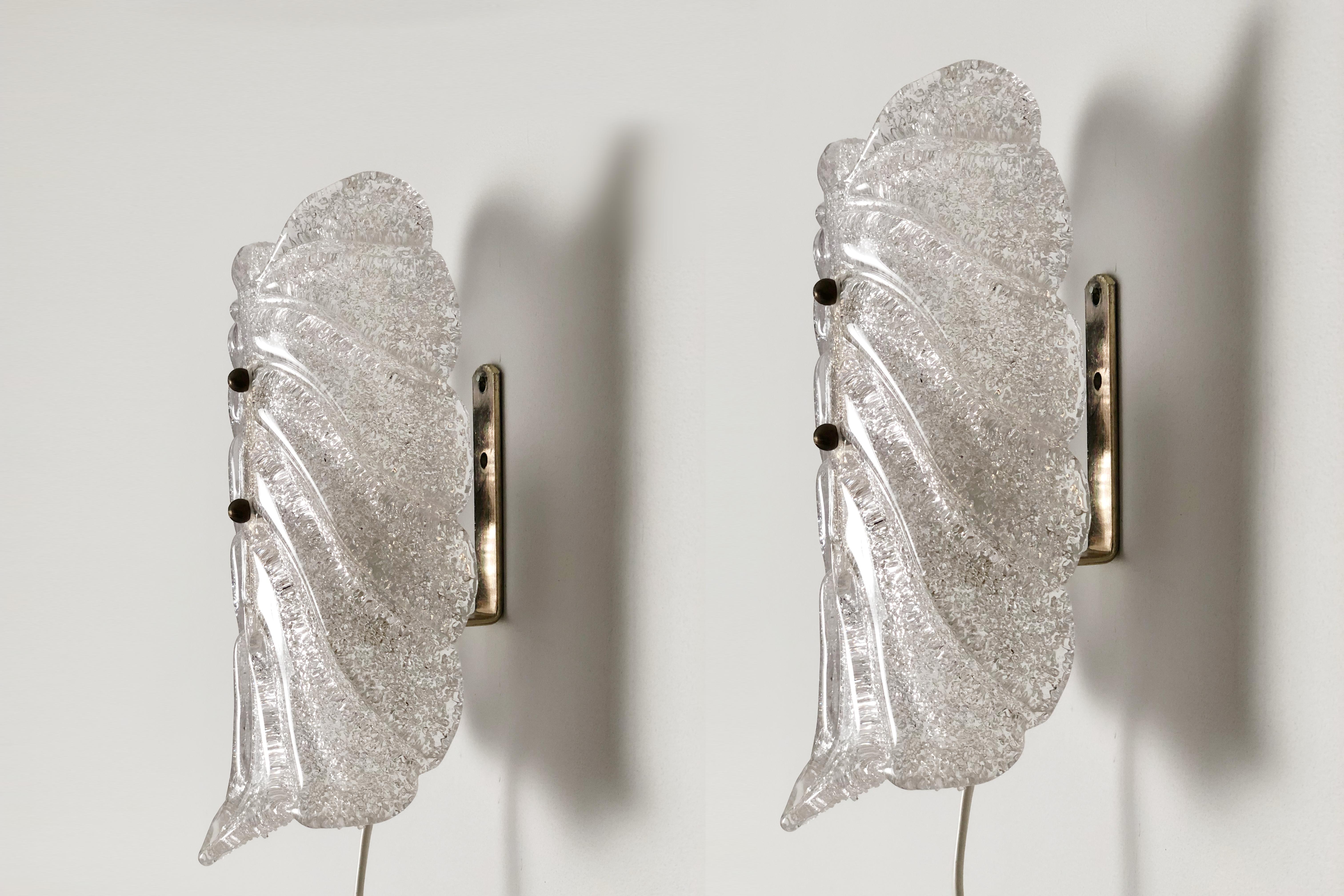 Offered for your consideration is a pair of 1960’s leaf shaped glass sconces in clear 'Patte de Verre' moulded glass. Each glass shade decorated on the back with semi-molten granulated glass fused to the shades while still molten, achieving the