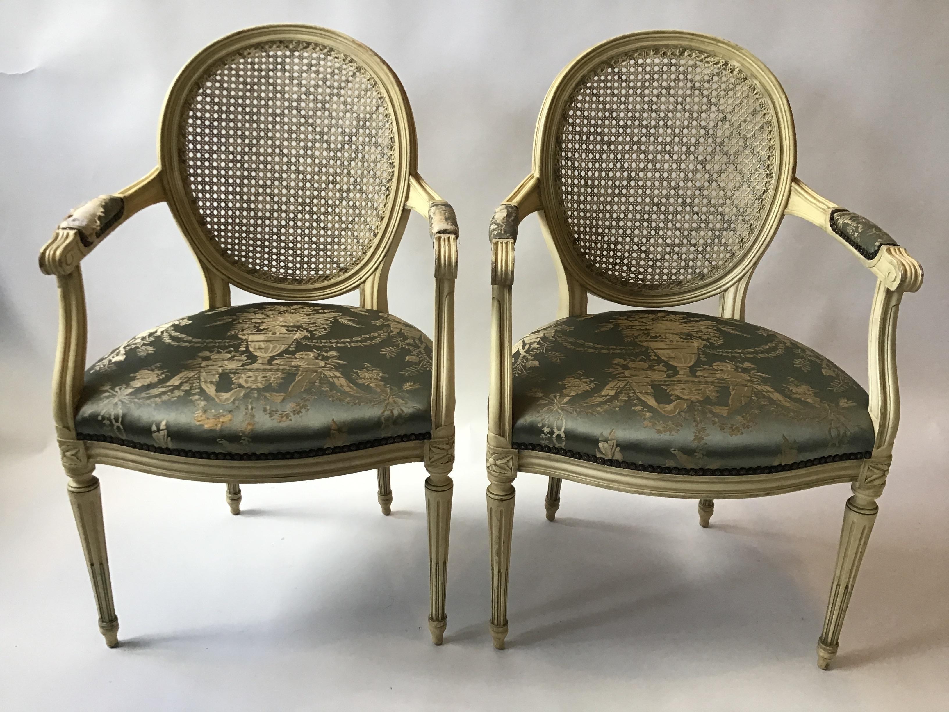 Pair of 1960s Louis XVI caned back armchairs. Painted stripes on the caning. Well made. Purchased from a Greenwich, Connecticut estate.