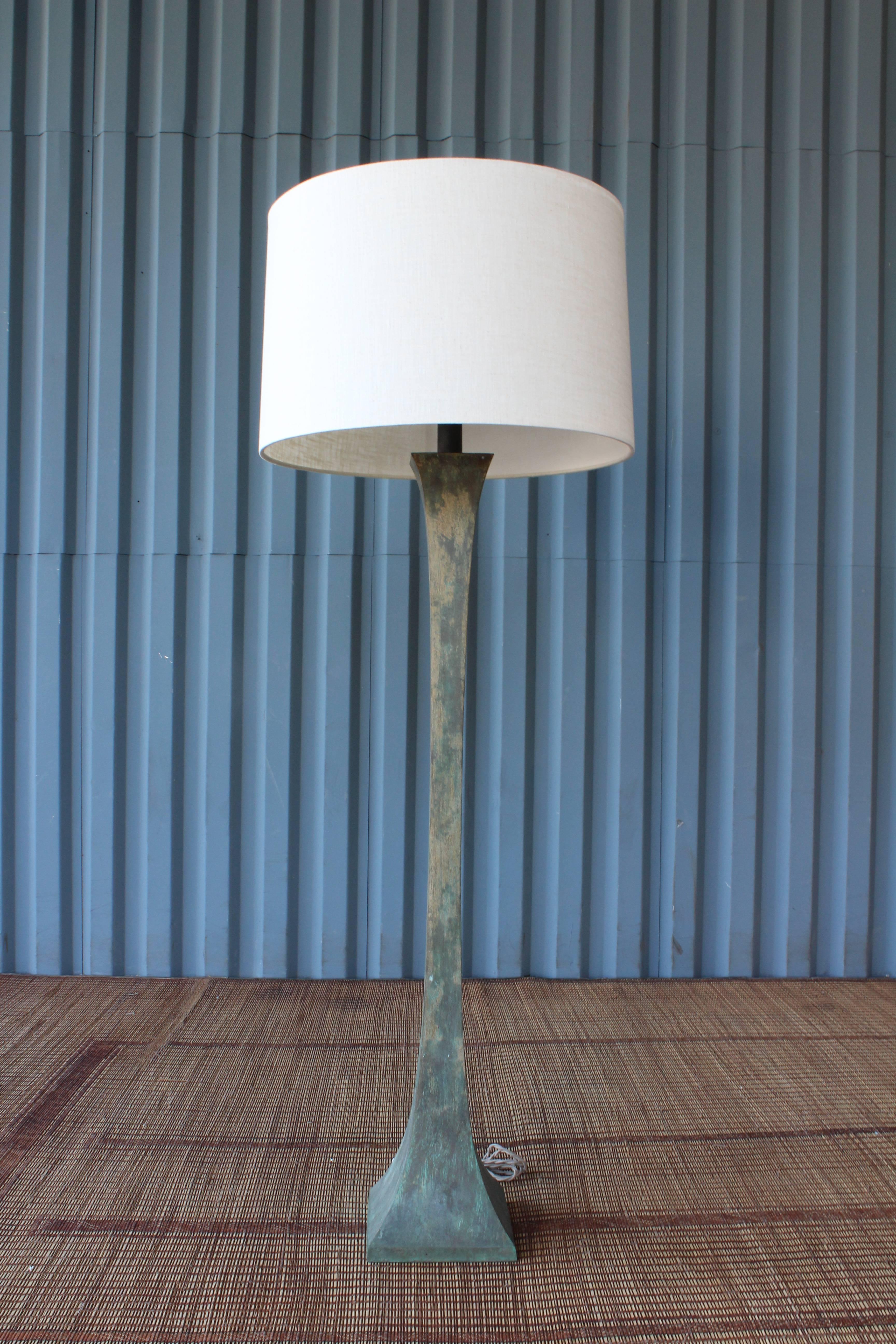 Pair of substantial steel floor lamps with heavy patina, circa 1960s. The pair have both been rewired and include custom-made linen shades. Priced individually.