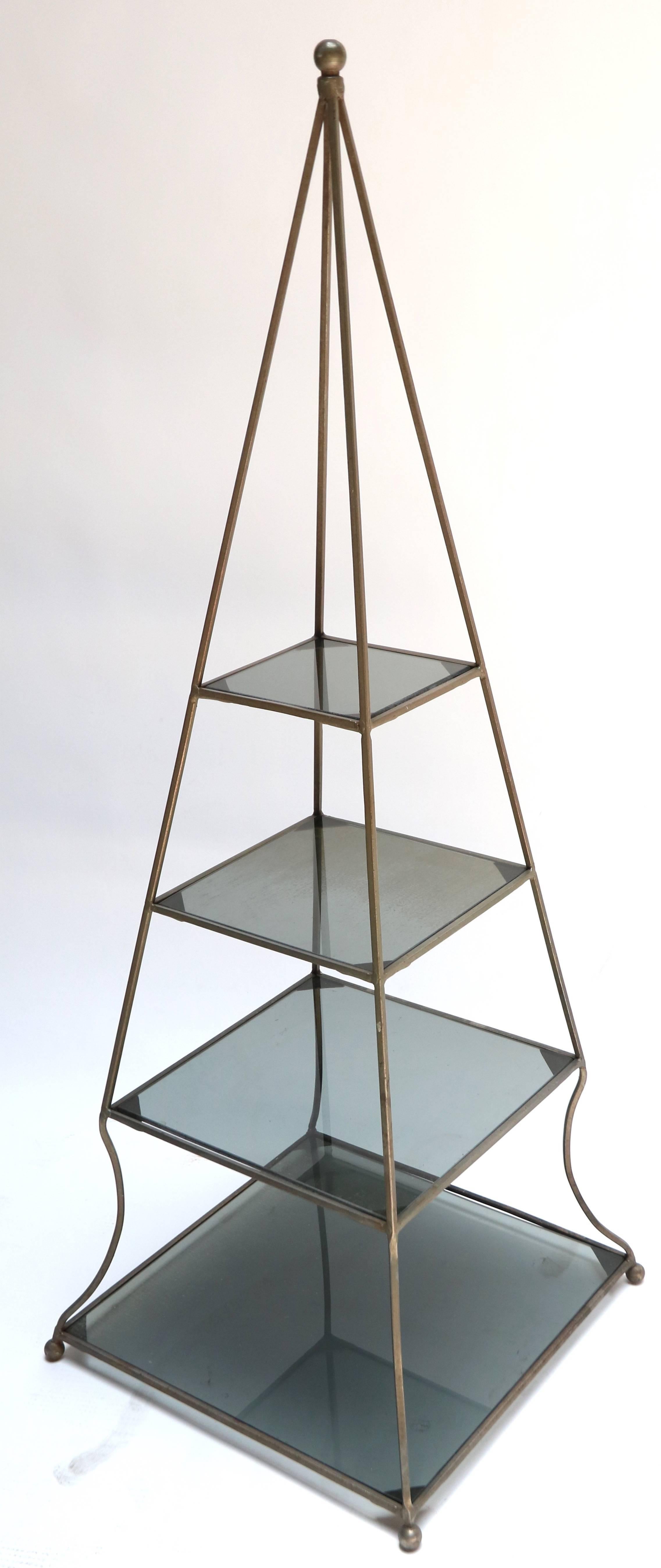 Pair of 1960s metal pyramid étagères with four smoked glass shelves.