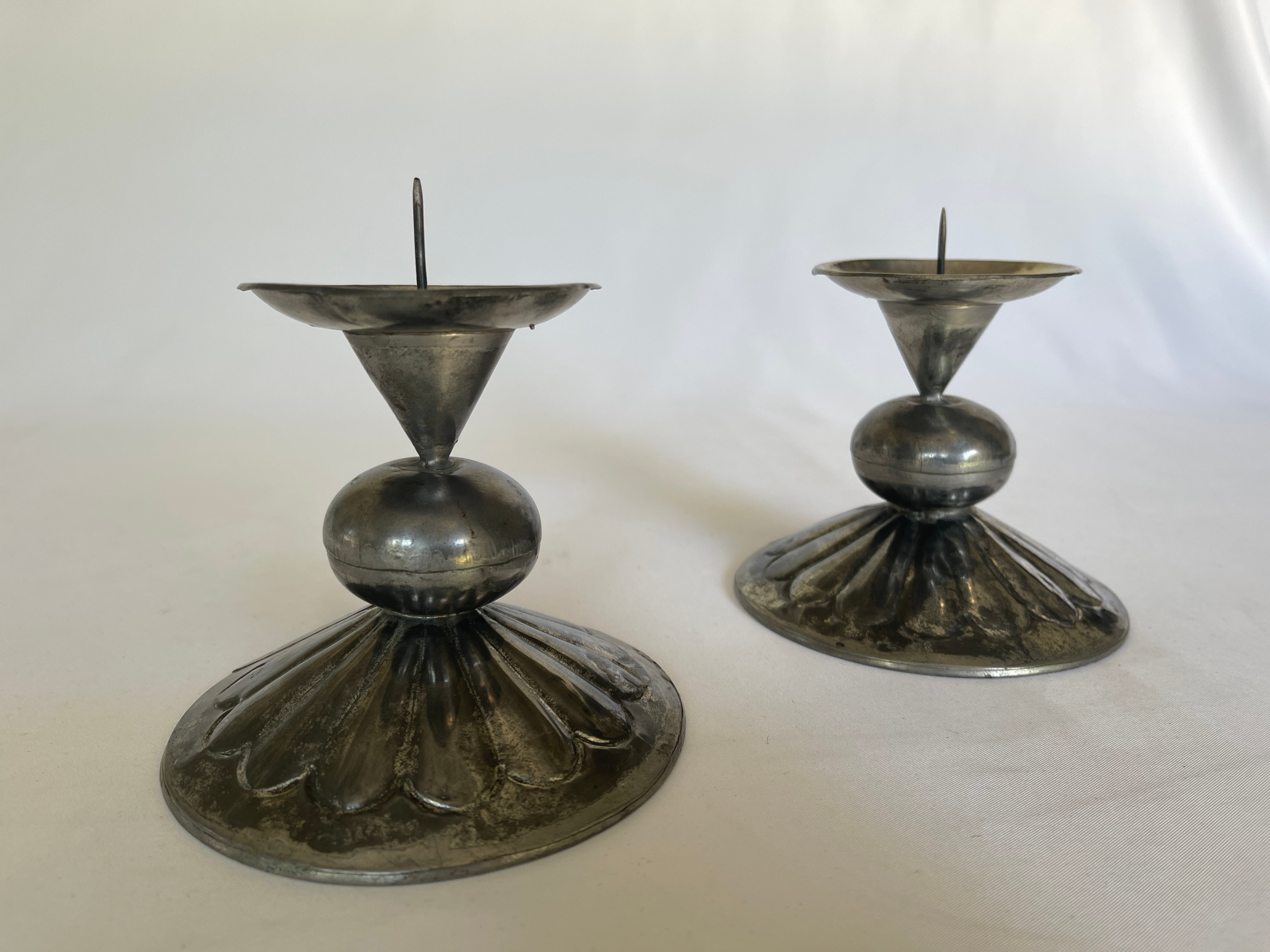 Pair of 1960's Mexican hand crafted tin candlestick pillars with hand tooled pattern on base. Signed with stamp on bottom, Mexico.