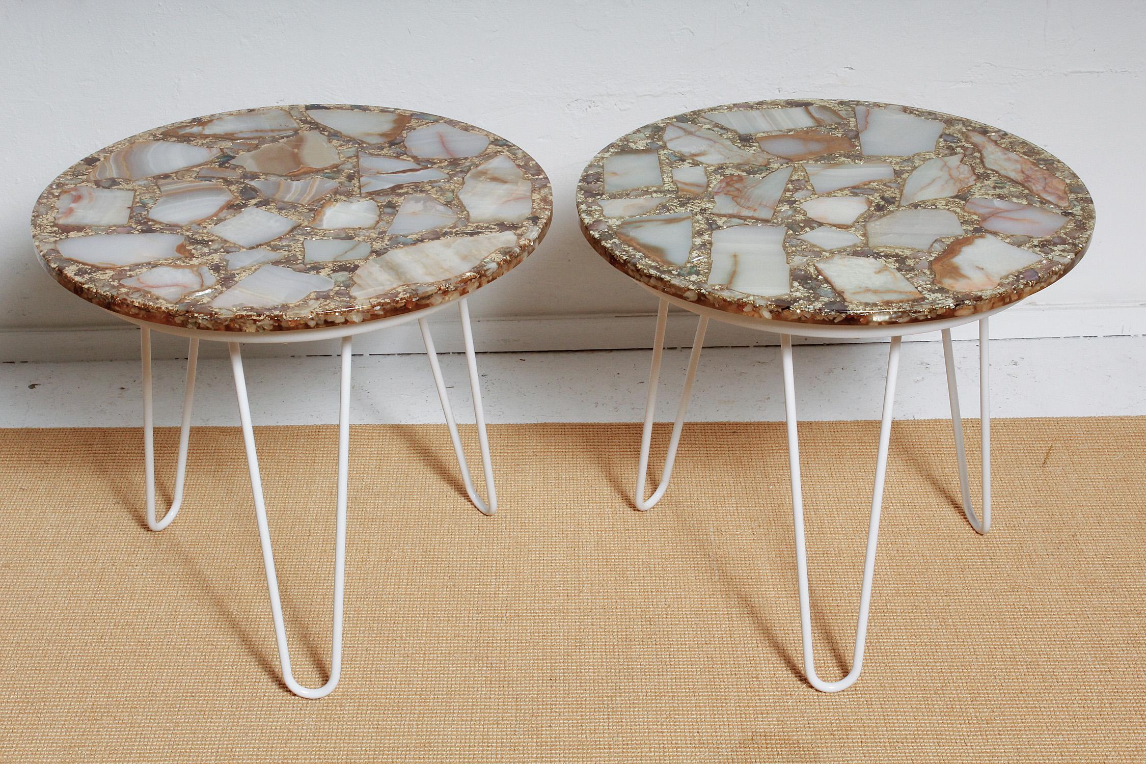 Fun and fabulous pair of 1960s Mexican side tables feature onyx specimens surrounded by bits of abalone and chunky gold glitter, all set in polished resin and perched atop white powder-coated hairpin legs.