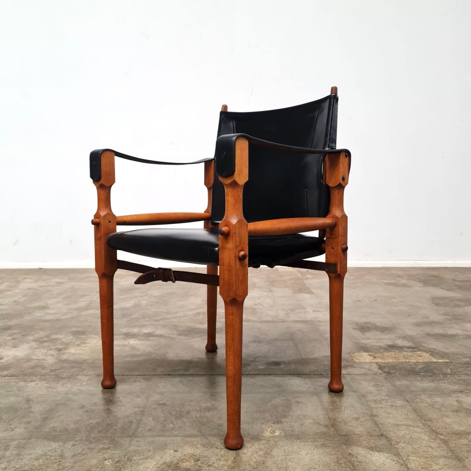 A pair of 1960s Safari chairs designed by Australian Michael Hirst. Based on the Indian Roorkhee Chairs used by British military officers.

Frames have been stripped and polished, The leather straps and foux leather base have all been cleaned and