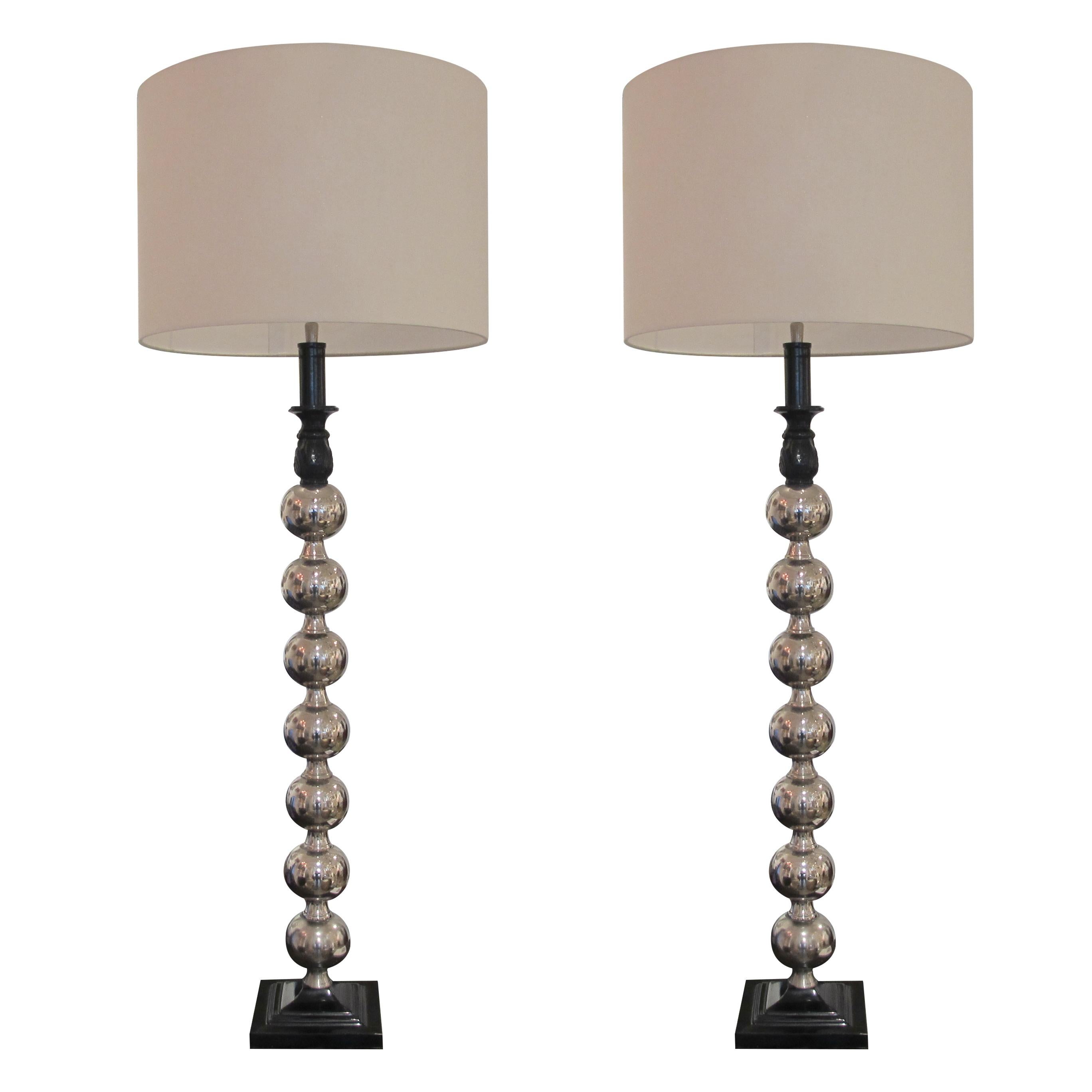 An elegant pair of 1960s Mid-Century Modern lamps with polished chrome spheres or orbs in the style of George Kovacs. The lamps are very versatile and can be used as either table or floor lamps and will suit many interior styles. The metal bases are