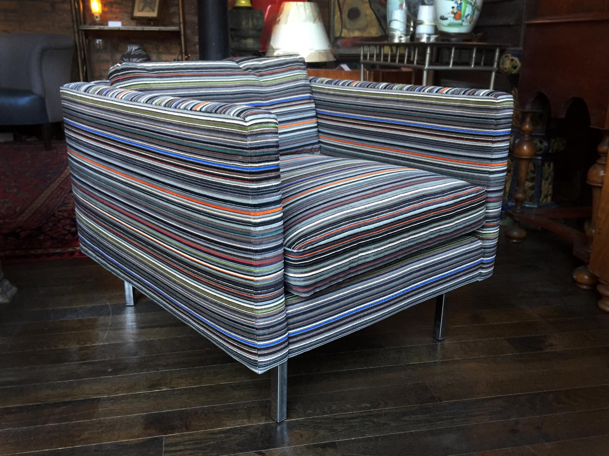 These exquisite Milo Baughman club chairs were manufactured by Thayer Coggin in the 1960s. They are newly reupholstered in a rich Paul Smith striped velvet from Maharam. The stunning textile adds movement and color to an otherwise Minimalist cubic