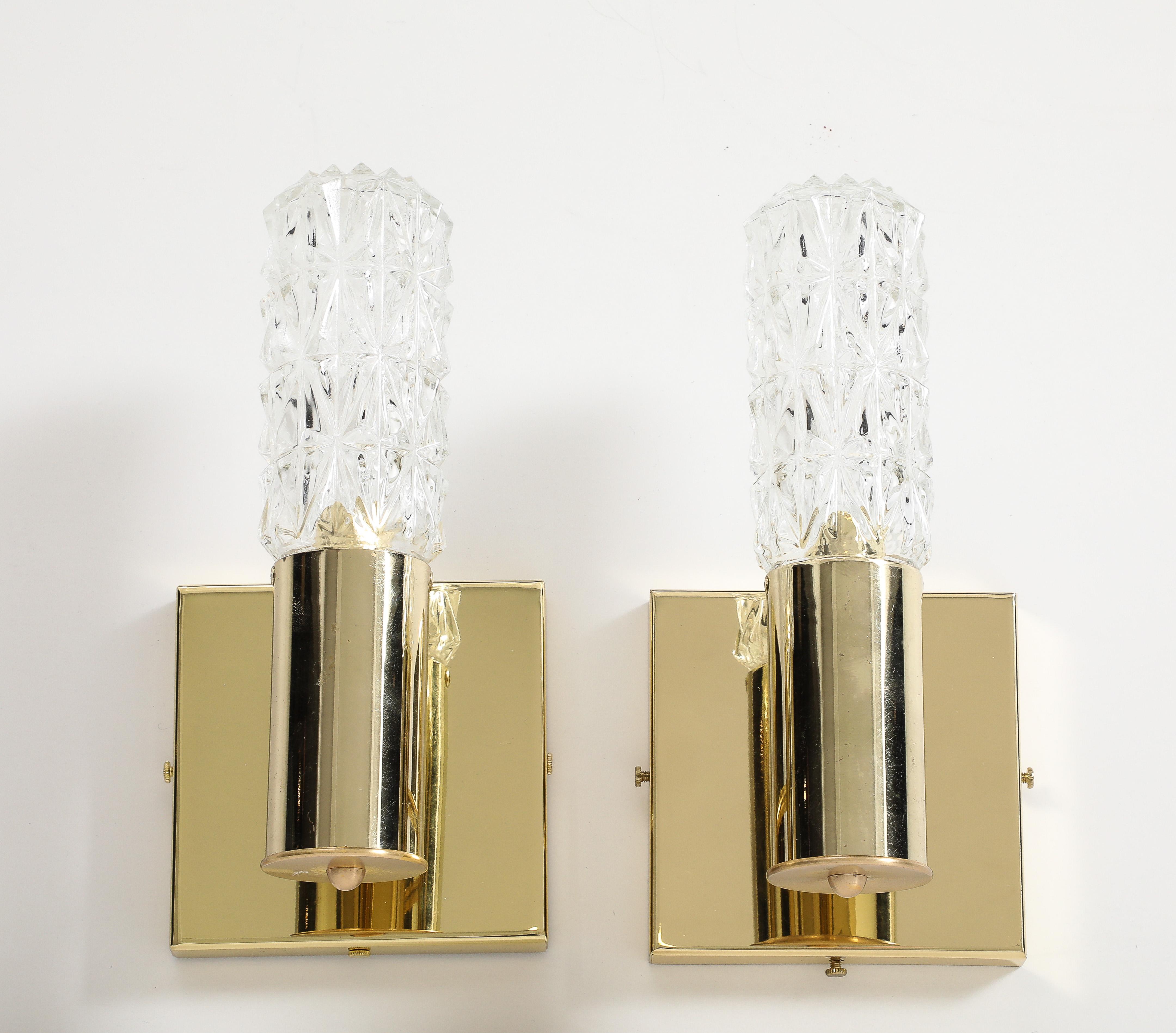 Pair of Minimalist Brass and Faceted Crystal sconces by Doria lighting company.
The 5