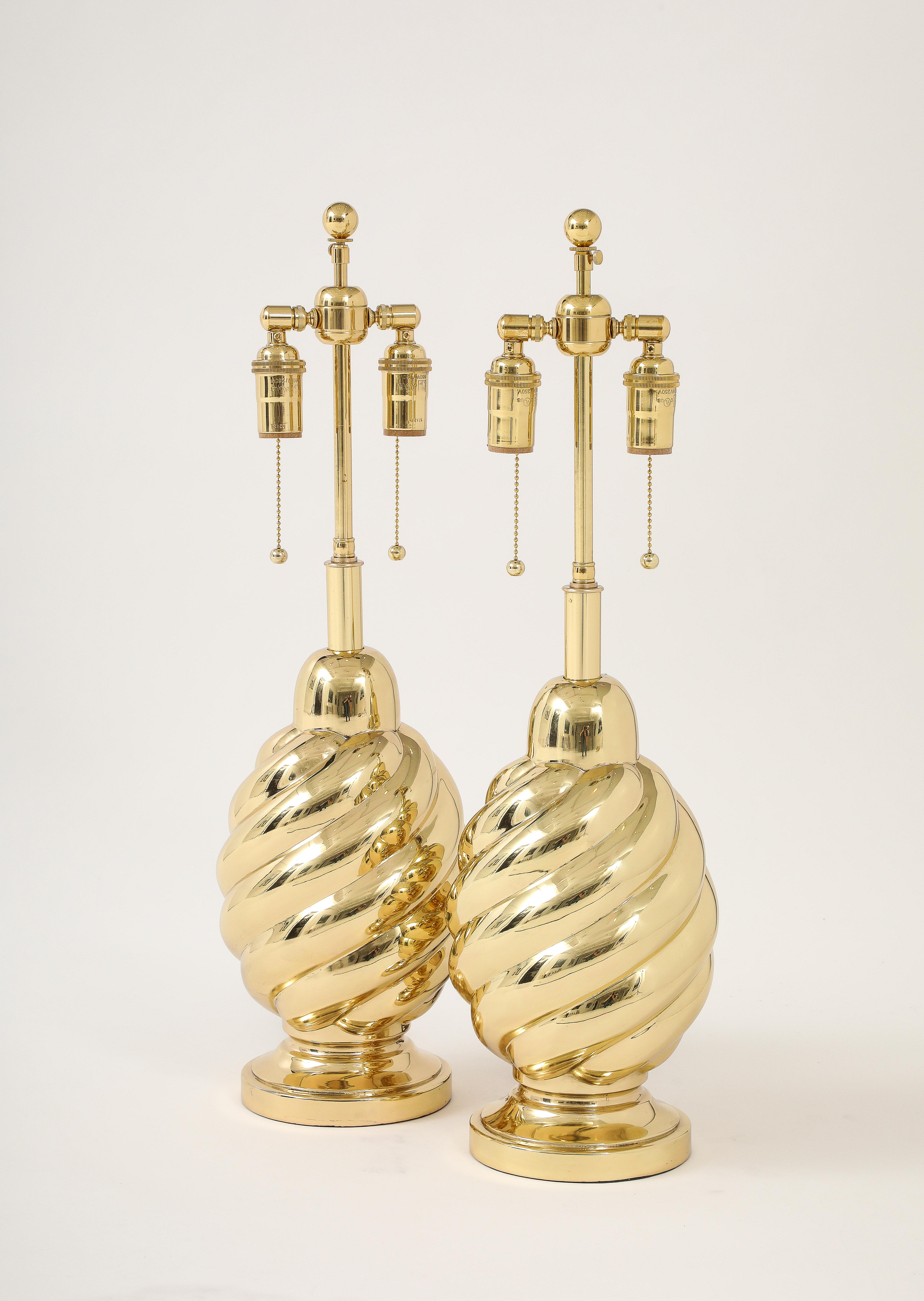 Pair of 1960's swirl lamps by Westwood industries.
The lamps have been Newly re plated and have a mirror brass finish.
They have been Newly rewired with adjustable polished brass double clusters and silk rayon cords.
Eat socket takes standard size