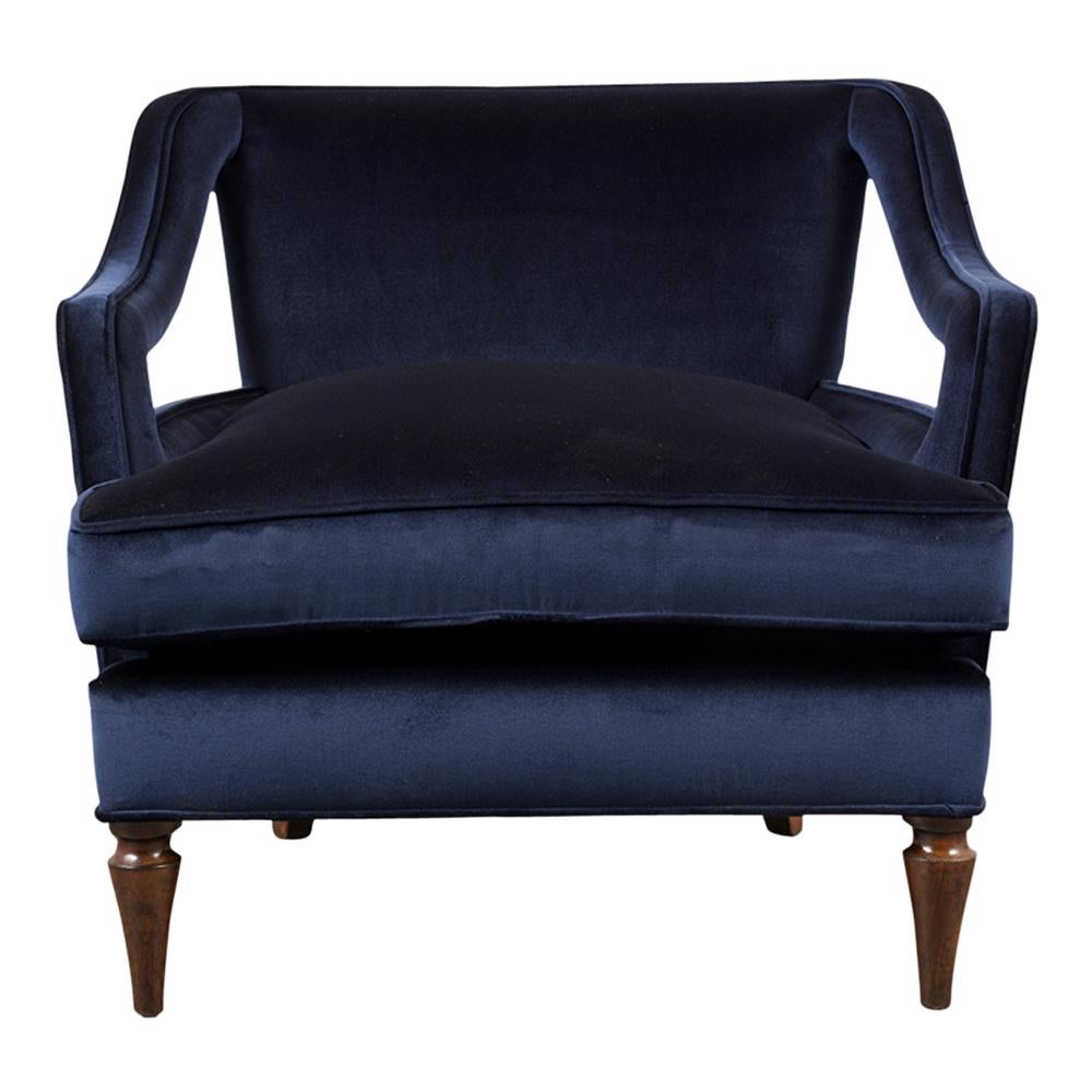 This Pair of 1960s Regency Lounge Chairs has been completely restored and feature a stylish curved back and open arm design. These club chairs have been professionally upholstered in navy blue velvet fabric with single piping trim details and
