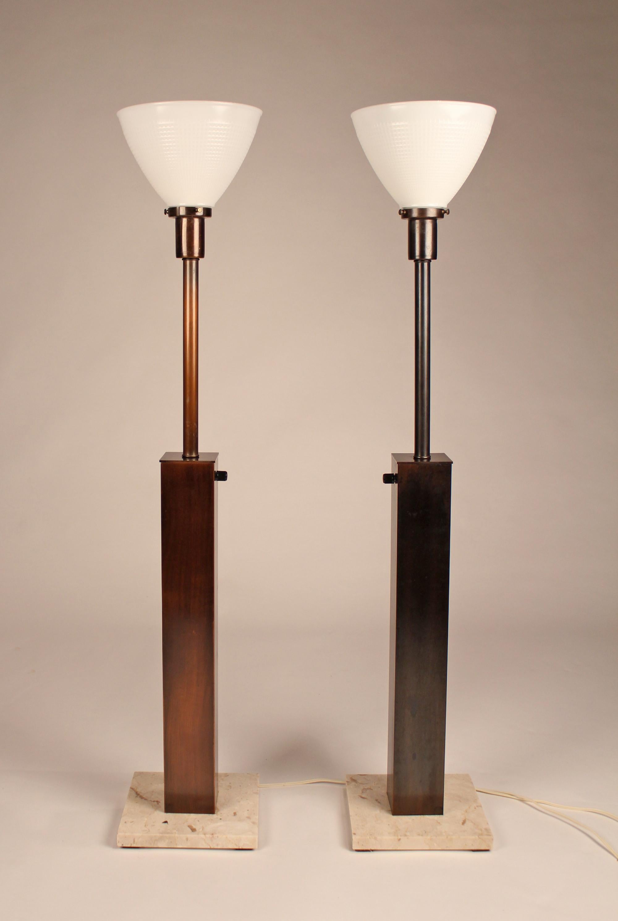 Pair of American made oil rubbed bronze table lamps with original glass diffusers, marble bases and fabric shades. Signed with paper Nessen NY label to underside.

Bases measure 8 x 8.

 