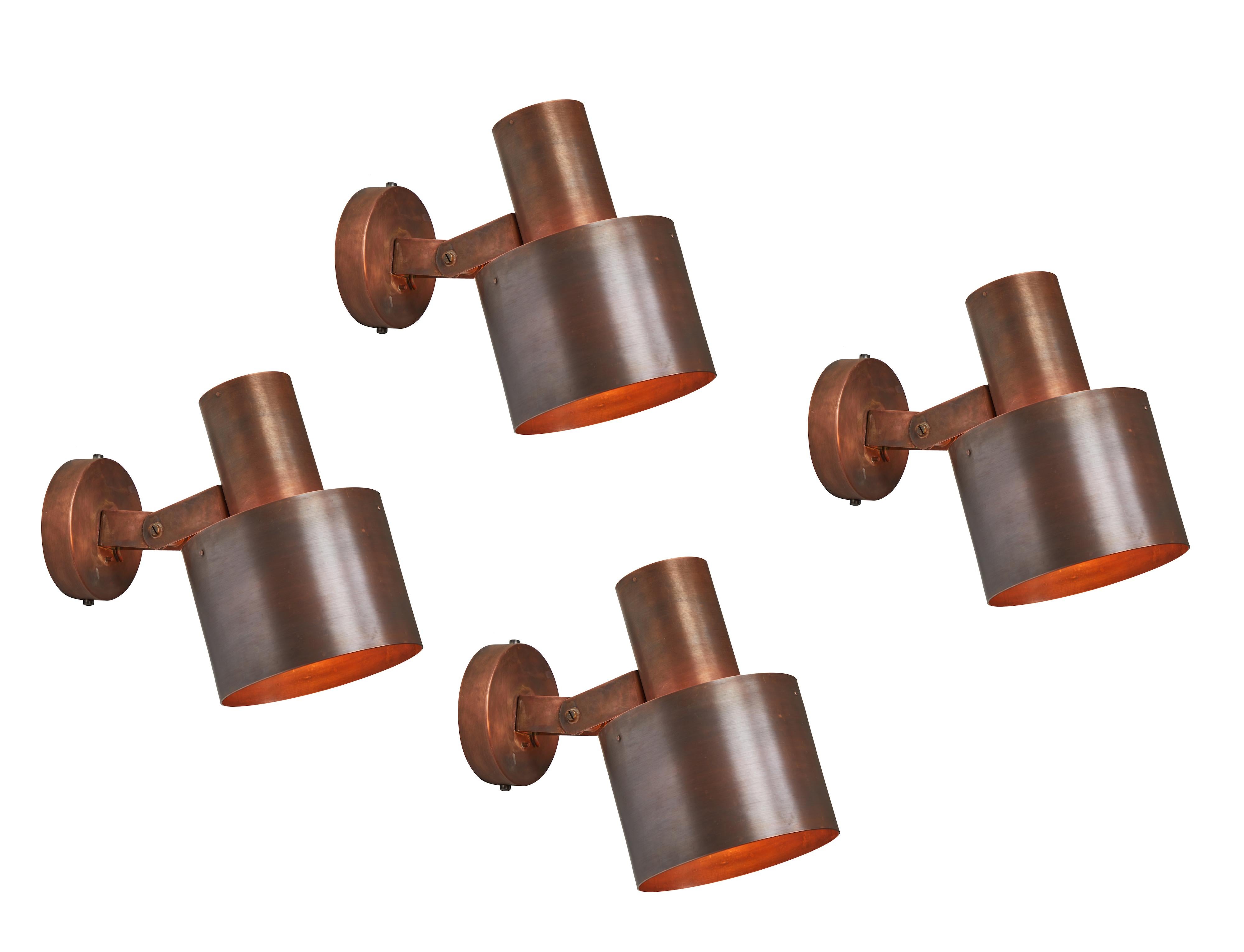 1960s Paavo Tynell copper wall lamps for Idman Oy. These rare and exceptionally refined wall lights are executed in a rich and attractively patinated copper. Signed with manufacturer's mark to back shade of each example, Finland, circa 1960s. Shade