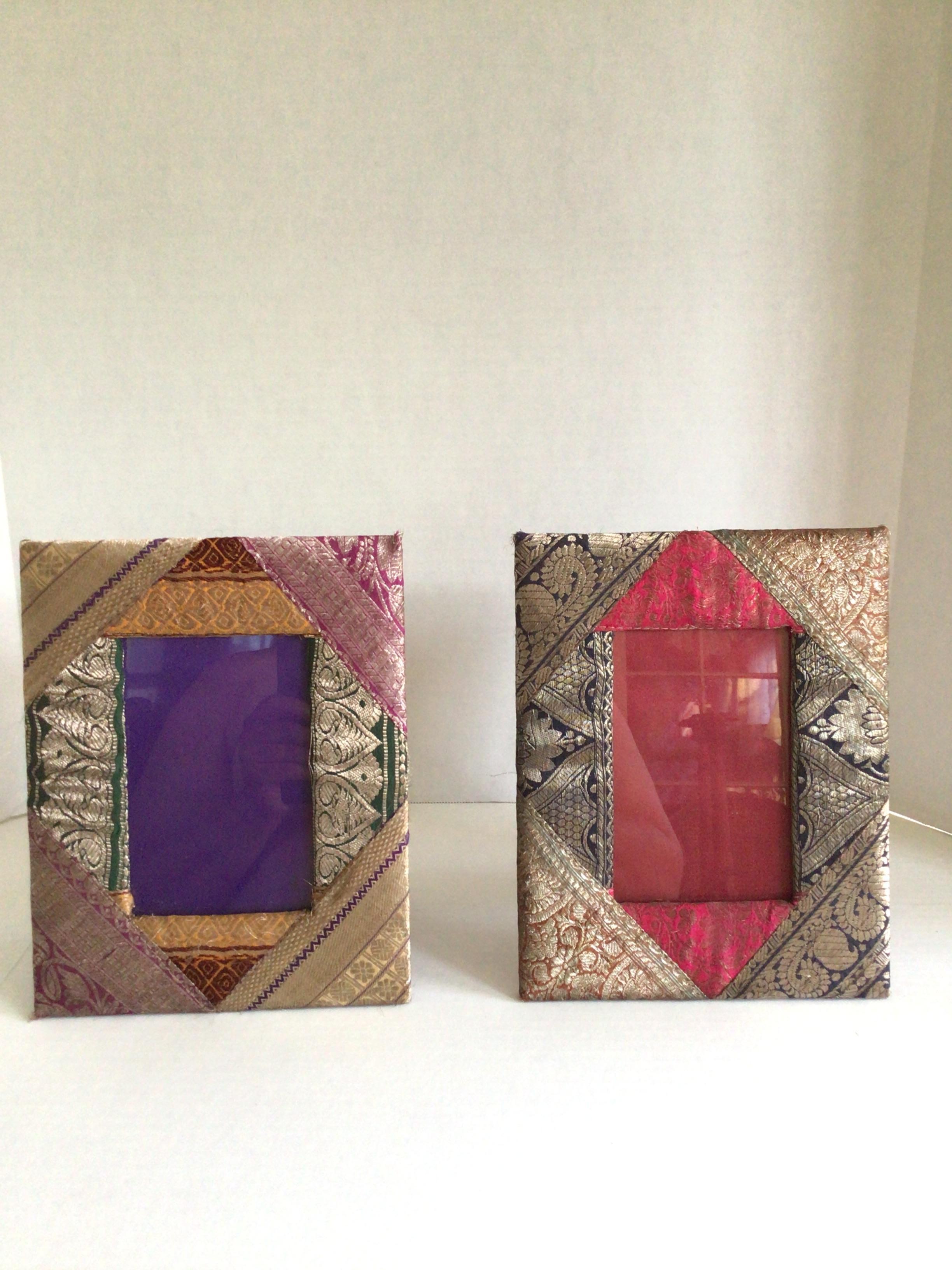 Pair of 1960s Picture Frames Covered in Brocade Fabric
Brocade woven fabric reminiscent of Sarees from India cover the border of these companion picture frames.
Bright pinks, purple, and greens make up the background of the gold motifs on the