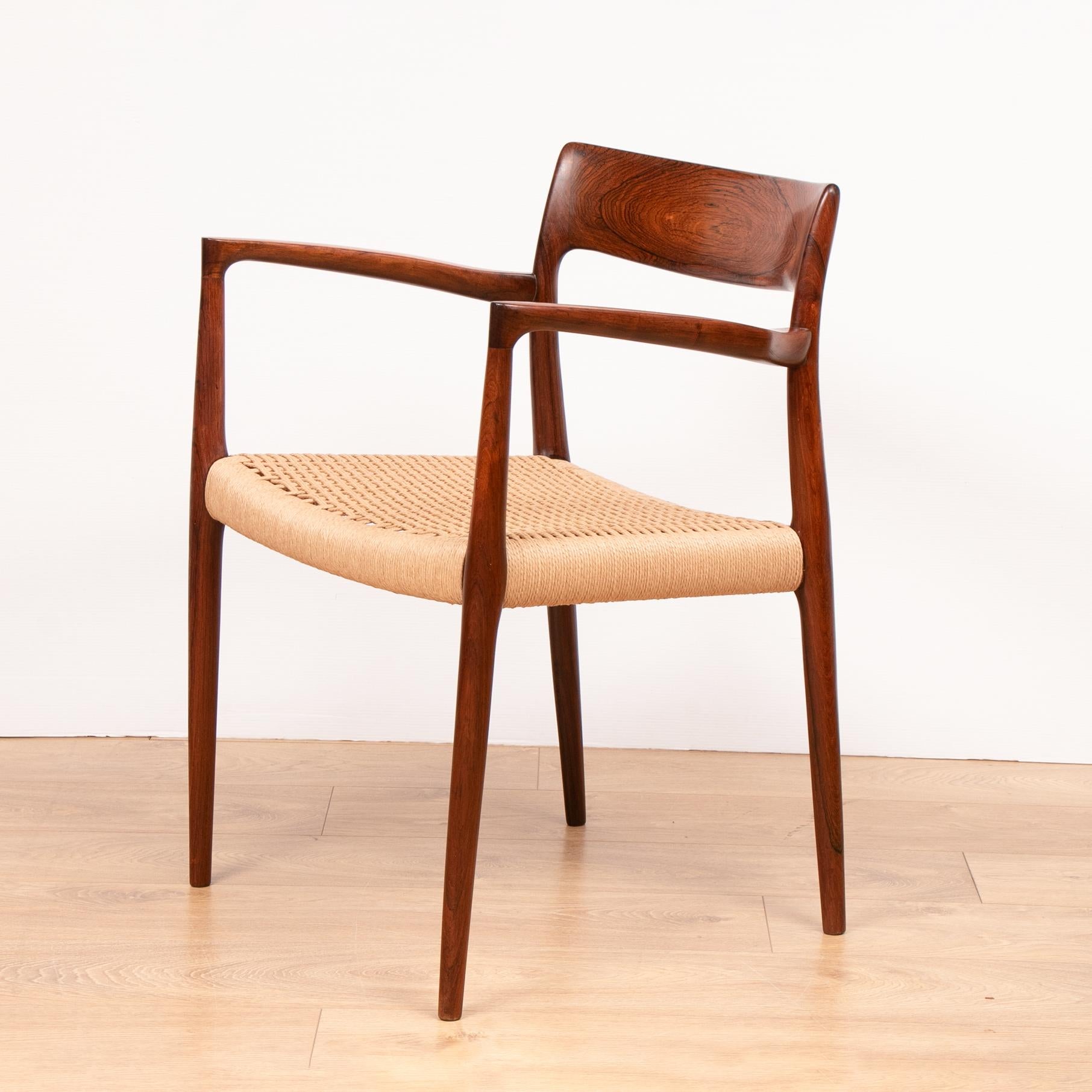 Pair of solid rosewood armchairs designed by Niels O. Moller and manufactured by J.L. Moller Møbelfabrik, Denmark in 1959. The chairs feature the most beautiful grain specifically on the backrests and arms. The chairs both have matching brand new