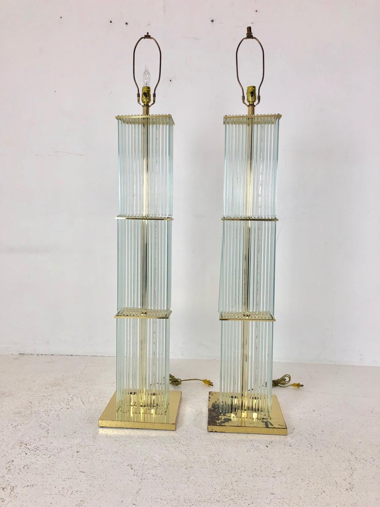 Pair of 1960s Sciolari brass and glass rod floor lamps. Brass will need re-plating and shades need repairing.

Dimensions:
11.25 W x 11.25 D x 56 T (top of harp) 57 T (top of shade)
shade:
22 W x 12 D x 13 T.