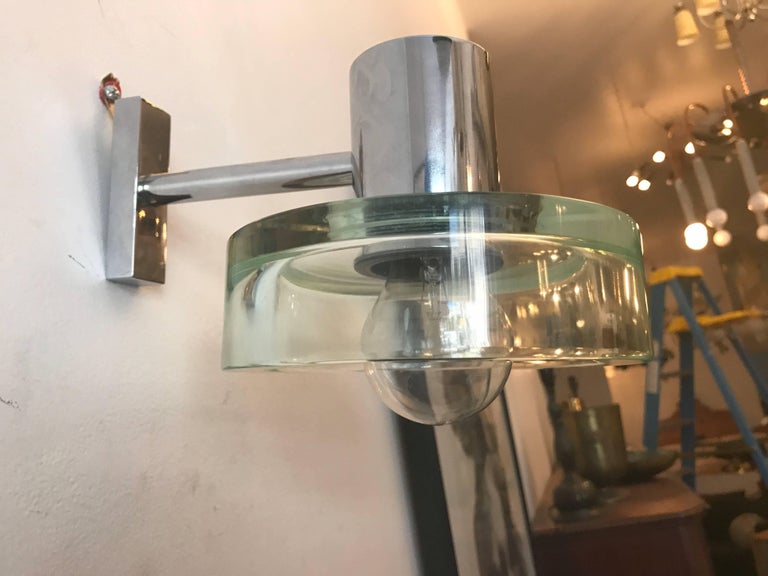 An original pair of 1960s Space Age polished chrome wall lights with thick green glass round shades by the famed Murano glass maker, Seguso. Newly rewired.