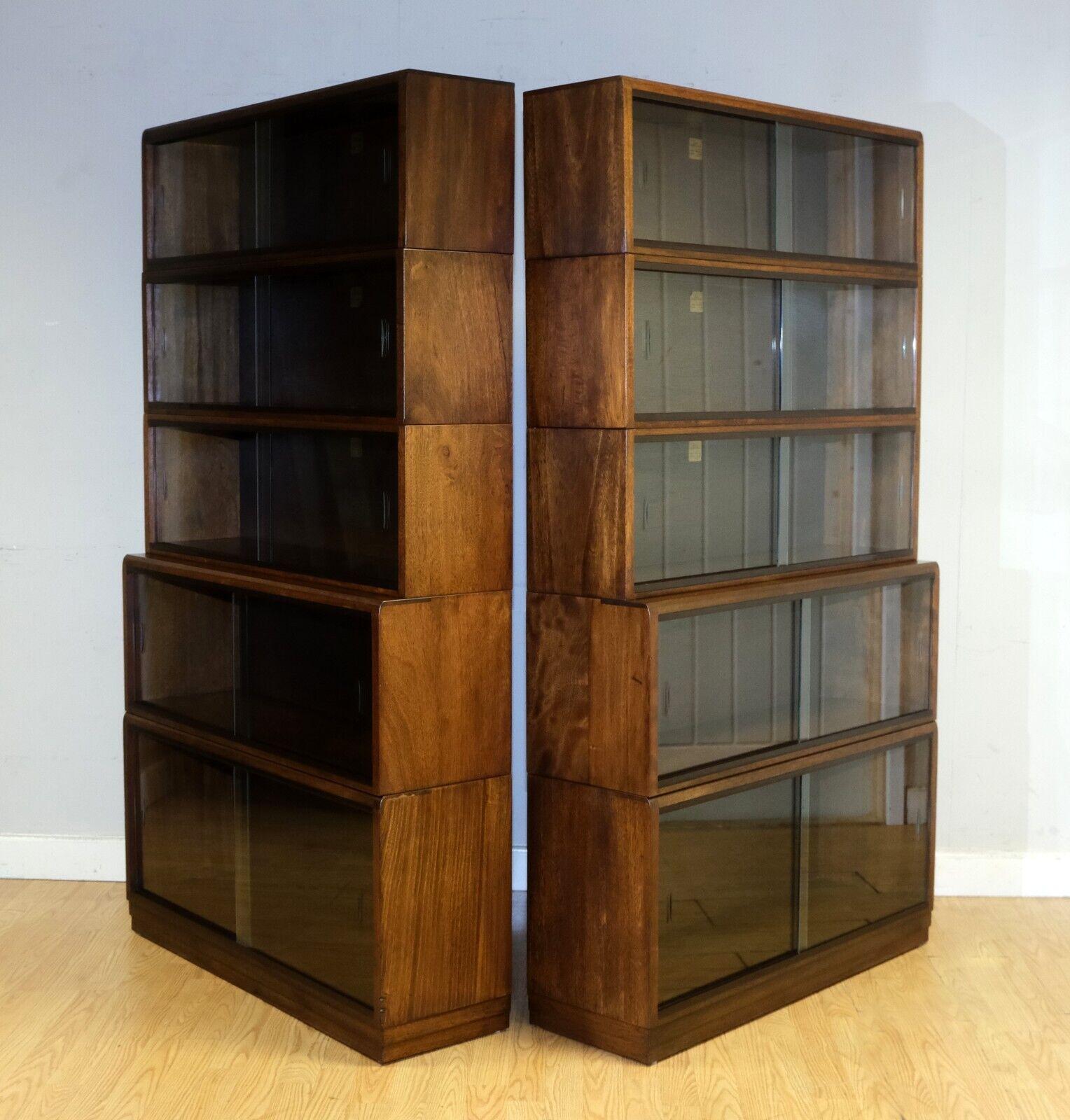 We are delighted to offer for sale thispair of stunning, Simplex, five piece, 1960's section bookcases in mahogany, with glass doors.

These are a great pair, both in very good condition with two original glass sliding doors to each section, both