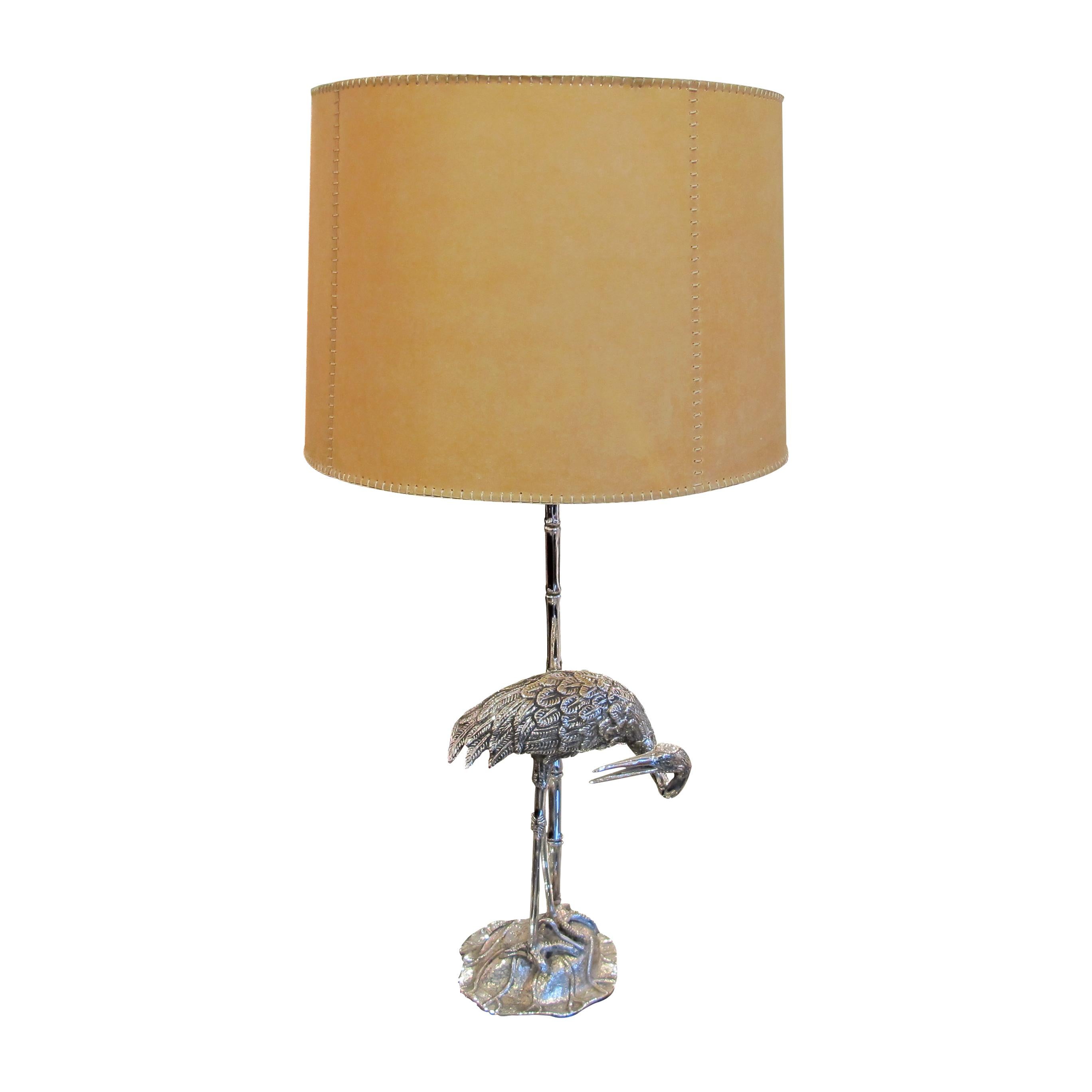A pair of 1960s Spanish silver plated Heron bronze table lamps by Valenti with handmade parchment shades. The lamps are a real statement of elegance with the beautiful curves and details of the herons' resting on silver plated bronze faux bamboo