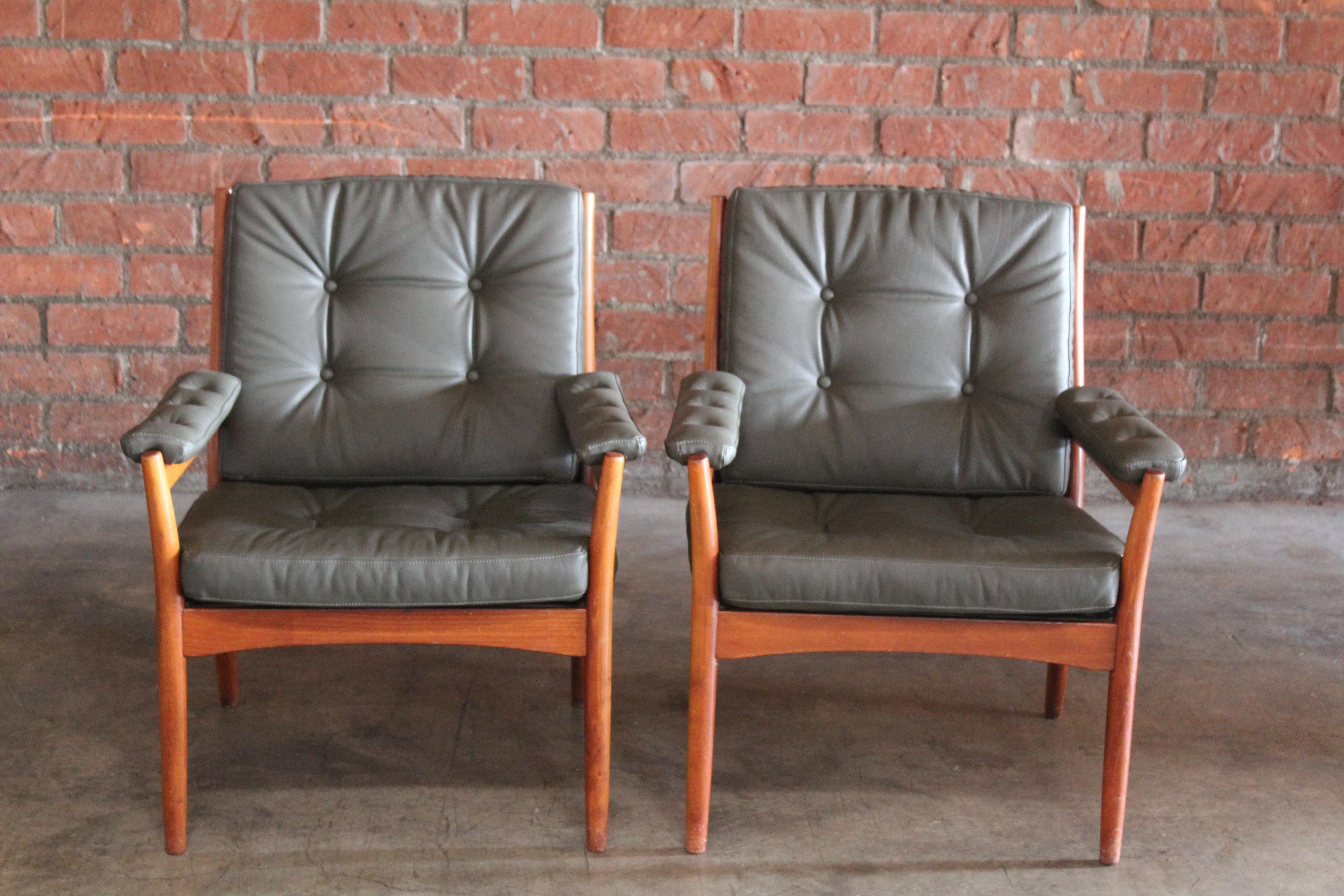 Pair of 1960s beech wood lounge chairs by Gote Mobler, Sweden. They are in their original dark finish with new genuine leather cushions in dark olive green. The upholstery is in pristine condition. The frames show minor signs of wear. Sold as a