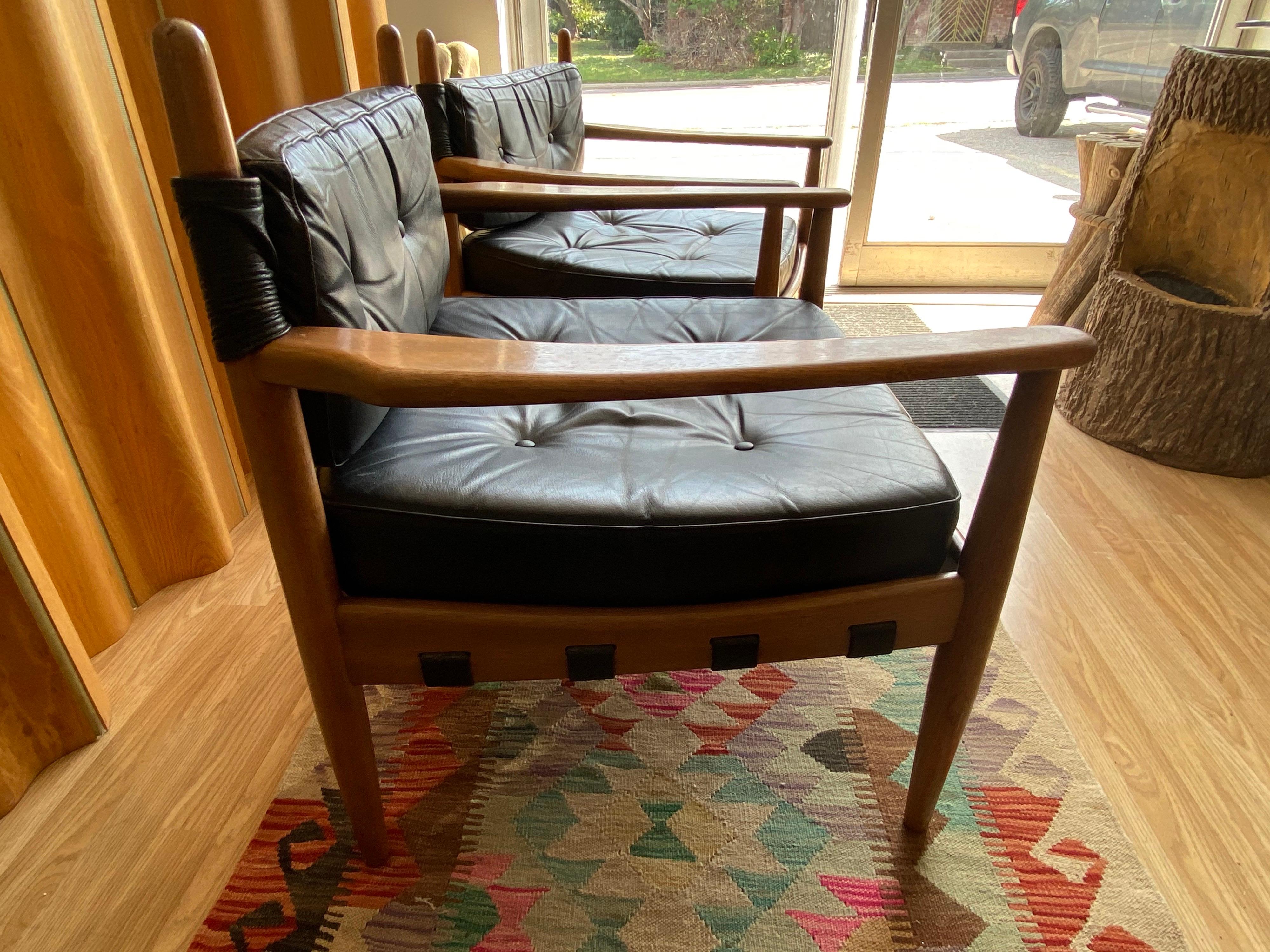 Beautiful pair of Mid-Century Modern leather lounge chairs designed by Eric Merthen circa 1960s, features nicely worn leather in black and is made of rosewood. This pair is in great overall vintage condition.