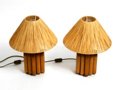 A pair of 60s table lamps by Temde made from solid teak with paper straw shades