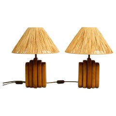 A pair of 60s table lamps by Temde made from solid teak with paper straw shades