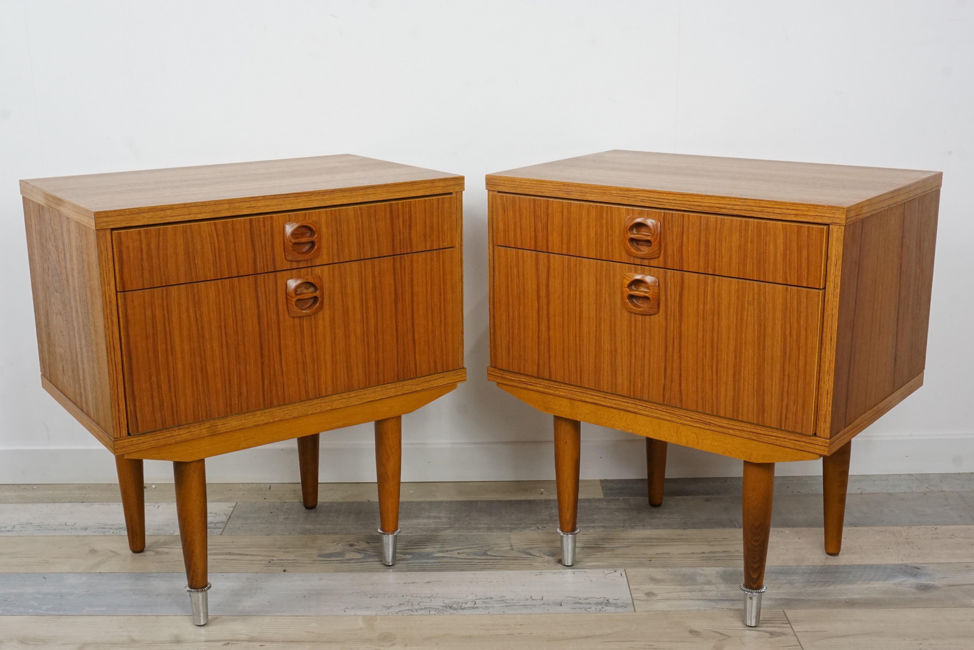 Pair of 1960s bedside tables, sculpted handles, compass feet chrome metal finish and 2 drawers with one bigger opening with flap. All in excellent condition.