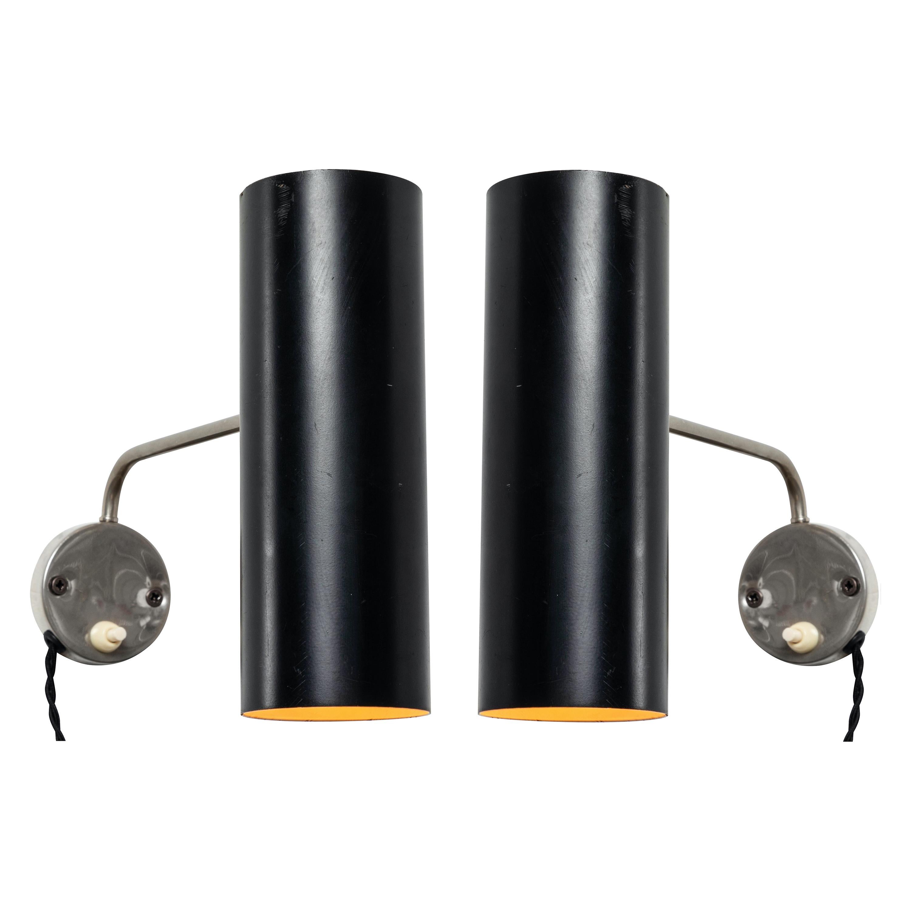 Pair of 1960s Tito Agnoli wall lights for O-Luce. An extremely rare matched pair executed in black painted aluminum and nickeled metal. One of his most highly refined Minimalist designs. A highly adjustable wall light, the arms can be rotated