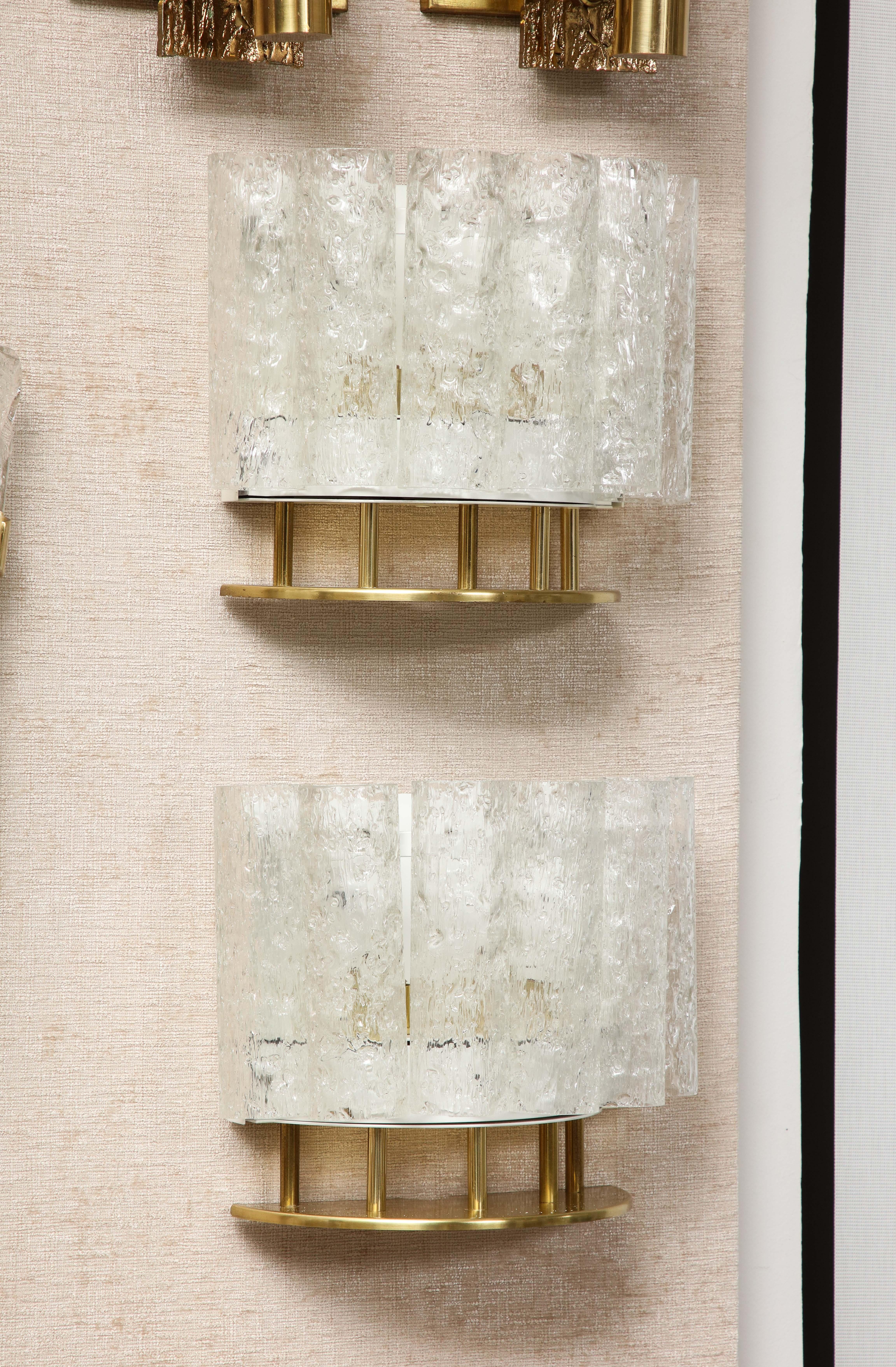 Pair of 1960's Brass and Textured Glass sconces by Doria lighting company.
Six textured glass tubes / cylinders form a Demi lune to create a shield of glass illuminated by two Newly rewired candelabra light sockets.
40 Watts per socket  / 80 watts