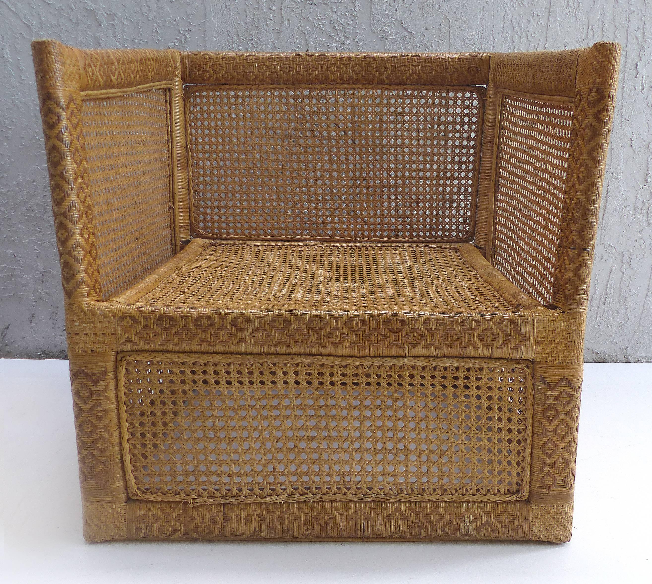 Offered or sale is a stunning pair of woven wicker and rattan club chairs acquired in Vietnam during the 1960s. These chairs were acquired by an American diplomat during his appointment in Vietnam. The chairs include cushions covered in vintage
