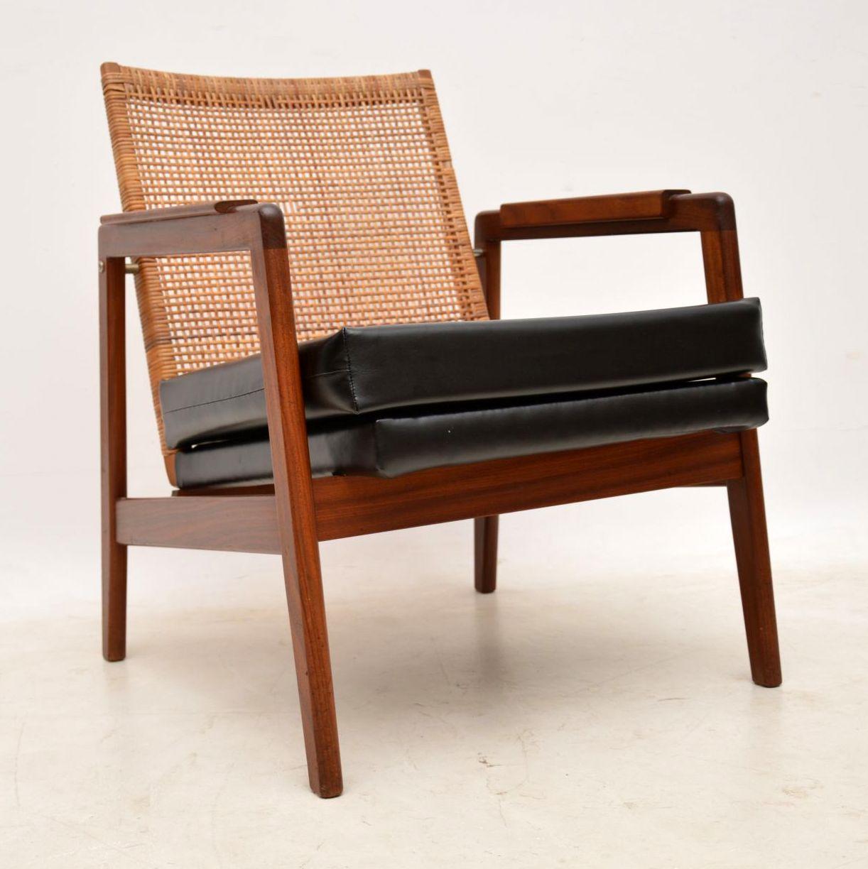 A striking pair of vintage armchairs, these were made in Holland during the 1960s. They were designed by PJ Muntendam and made by Gebroeders, they are of excellent quality and are in excellent condition for their age. The rattan backs give a