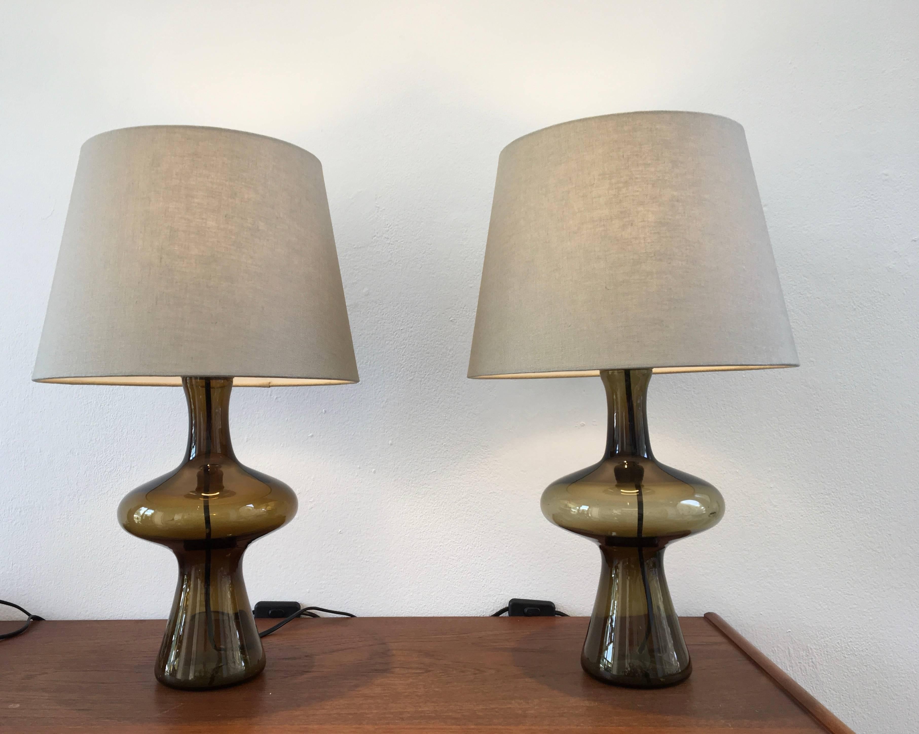 This pair of glass table lamps was produced by Danish company Holmegaard in the 1960s. The lamps have been rewired and have a new socket and lamp shades.