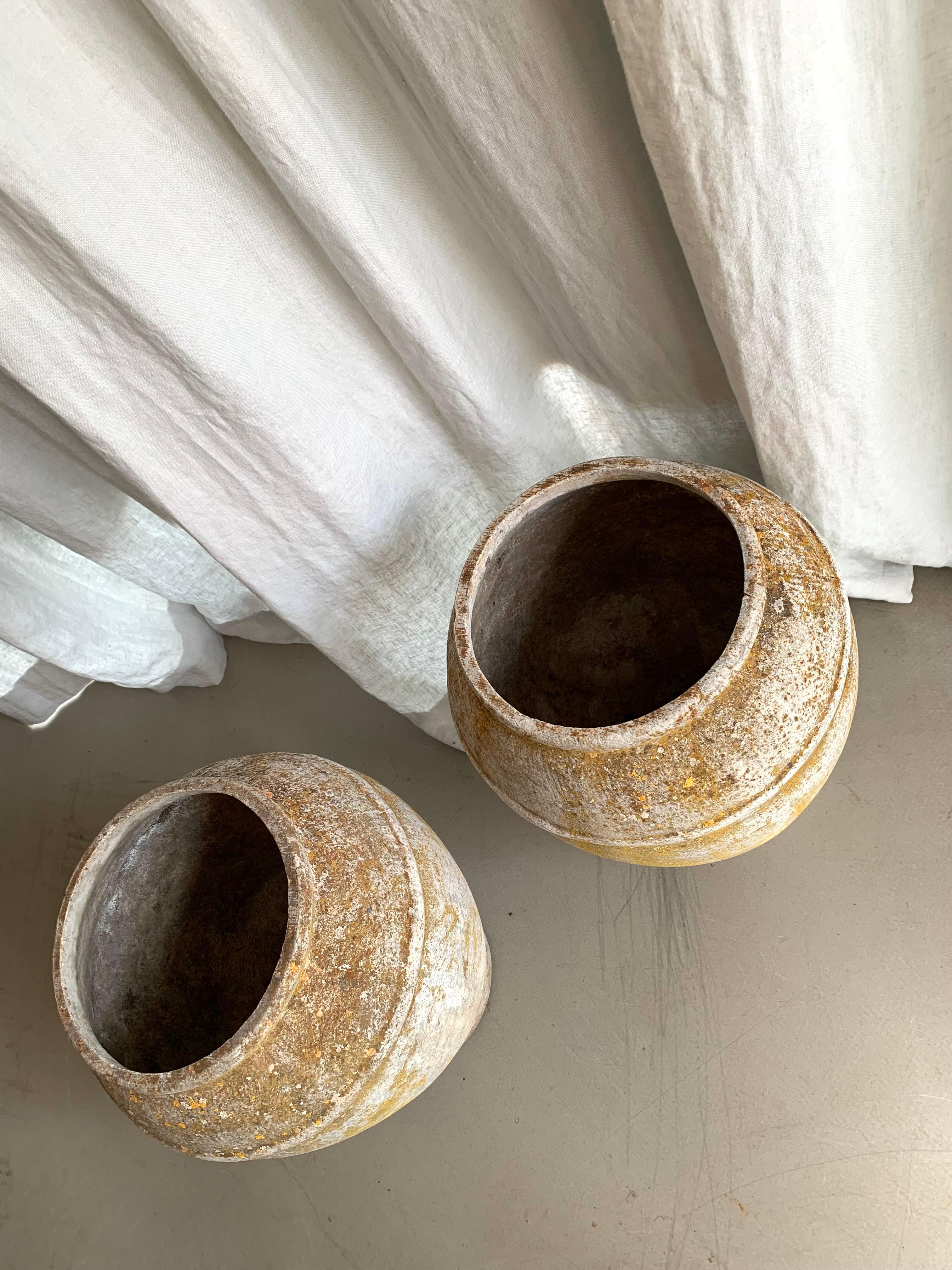 A rare pair of Willy Guhl vase shaped fiber cement planters with great weathered patina.