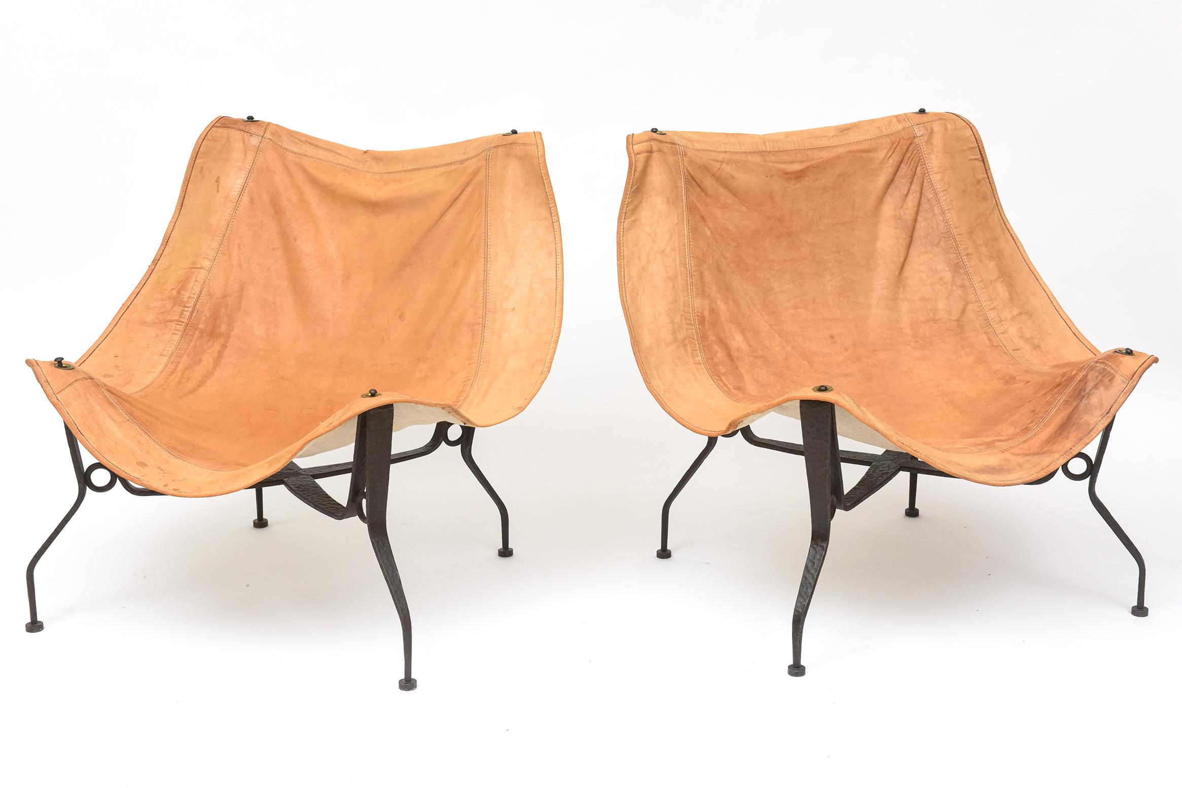 Artful wrought iron frames give these 1960s sling chairs a more polished look than most, while the softly worn, canvas-backed leather ensures their comfort.