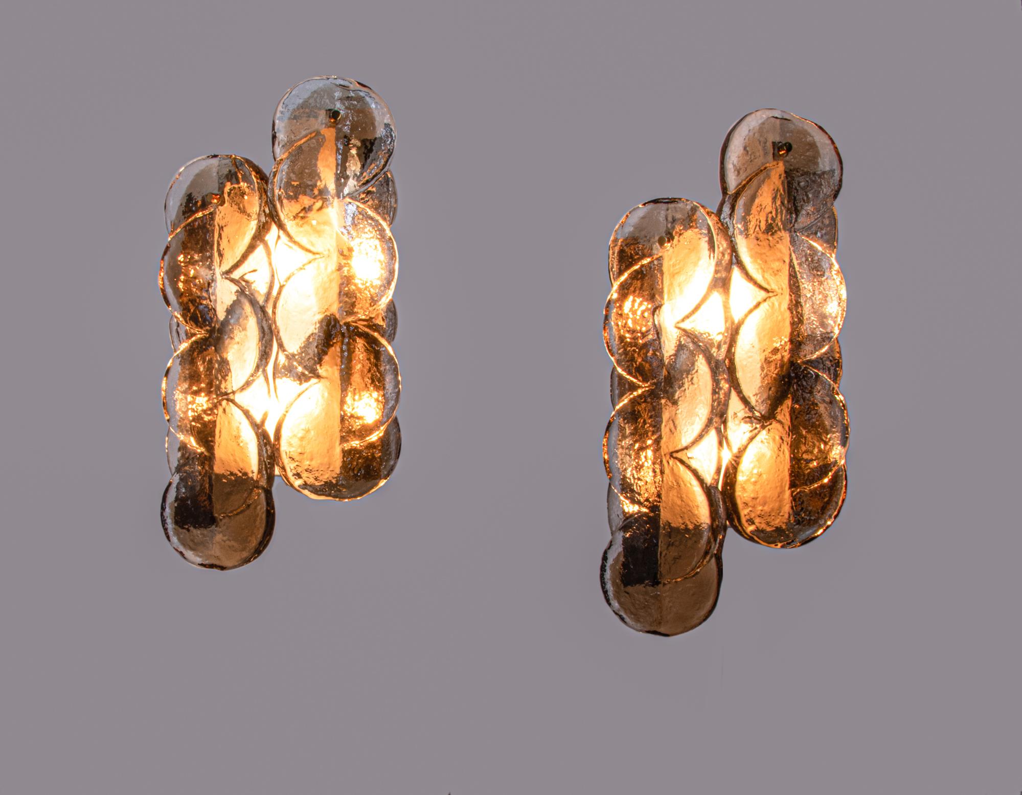 Elegant set of two amber-colored 'Citrus' wall lights with two swirled glasses per light on a metal frame with brass and chrome applications. The heavy handblown amber and clear Murano glasses have smoke-colored accents. Manufactured by Kalmar,