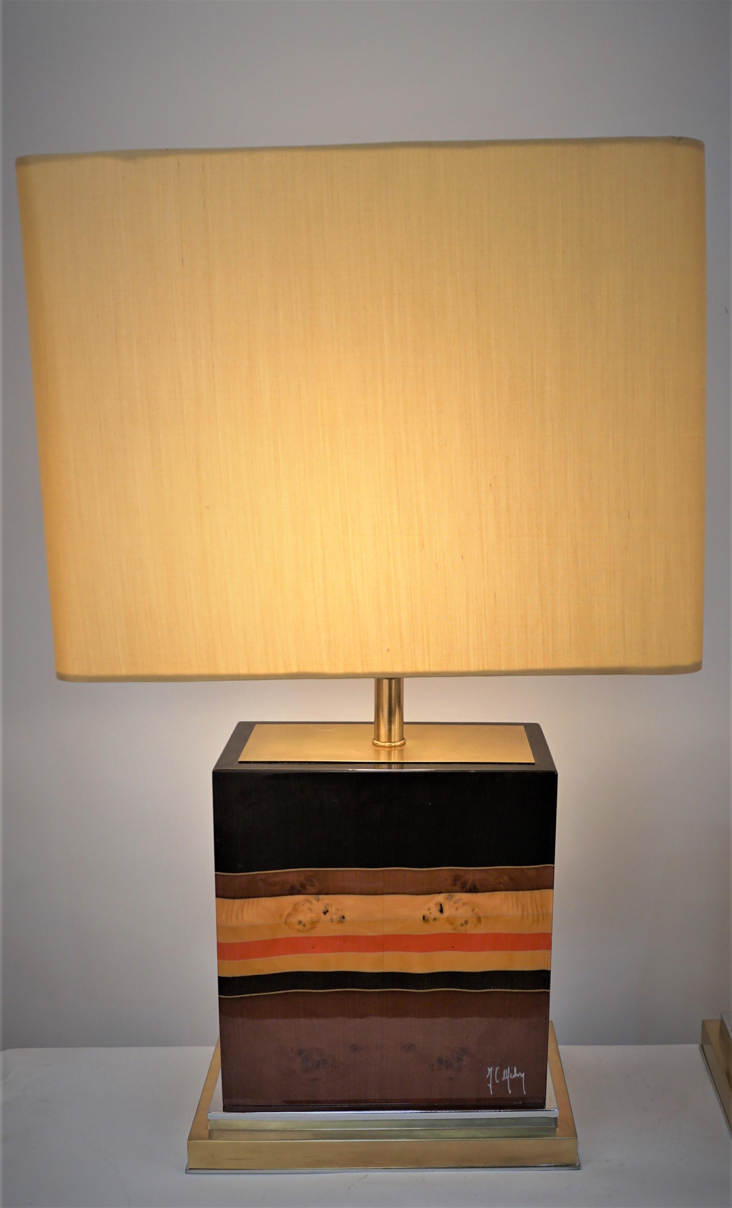 Elegant pair tables lamp designed by Jean Claude Mahey in the 1970's.
These multi color lamps are in heavy lacquer wood bronze and chrome base and hardware. 
Fitted with oblong silk hardback lampshades.