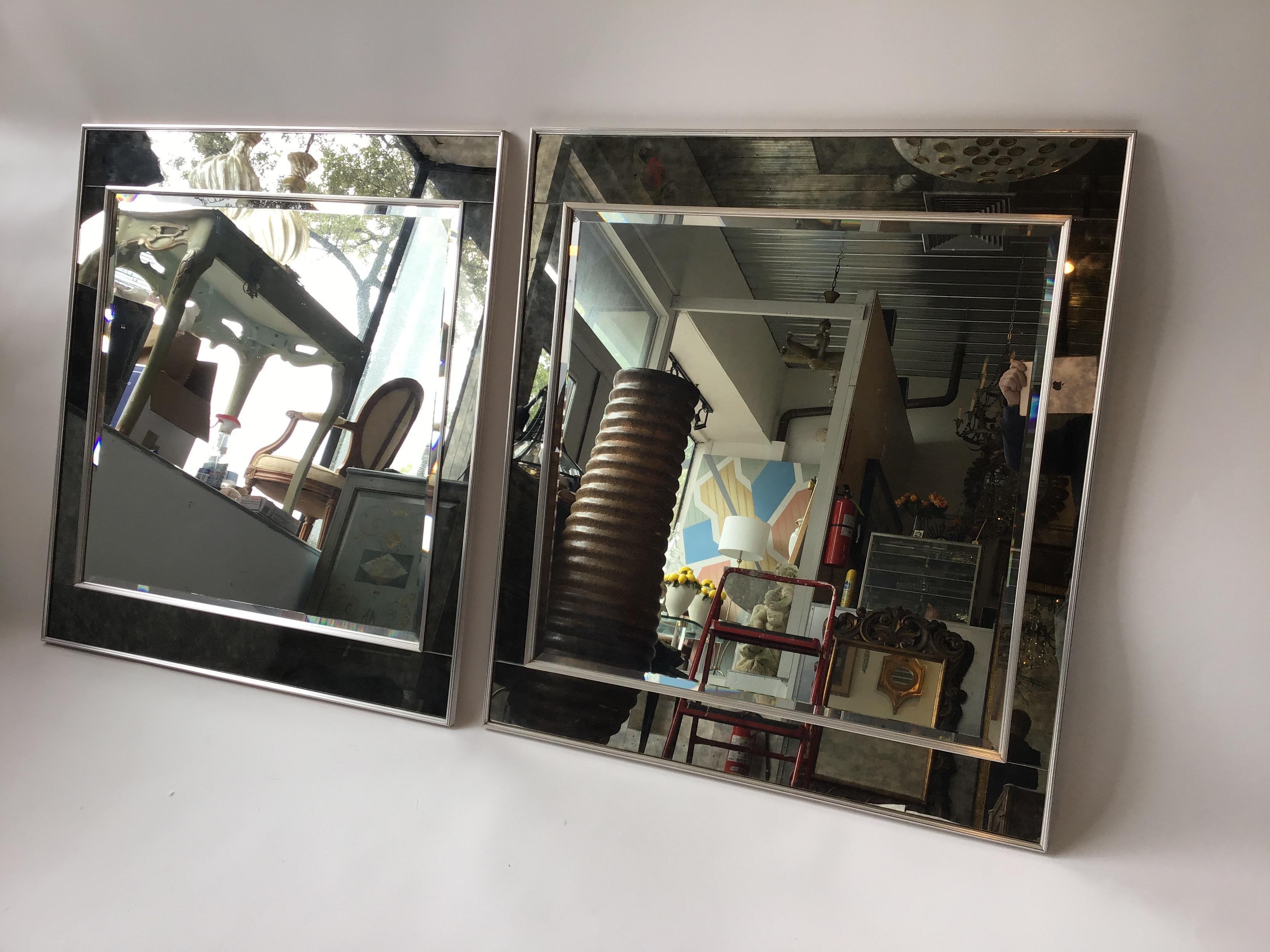 Pair of 1970s oversized chic, La Barge chrome framed mirrors. Smoked mirror border .Great quality. Out of a Southampton, NY estate.