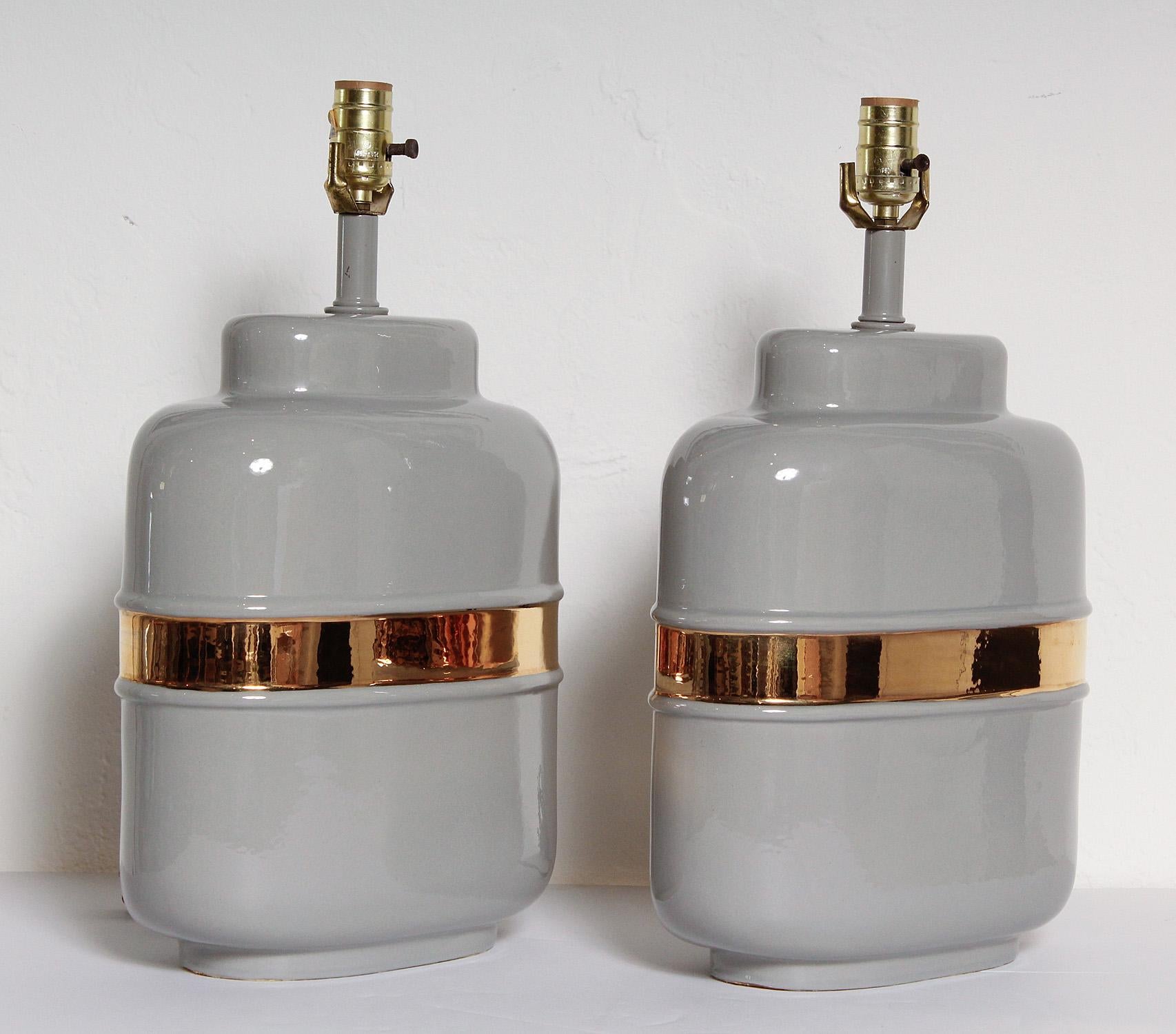 Simple and chic 1970s American ceramic lamps glazed in warm grey and 24-karat gold.