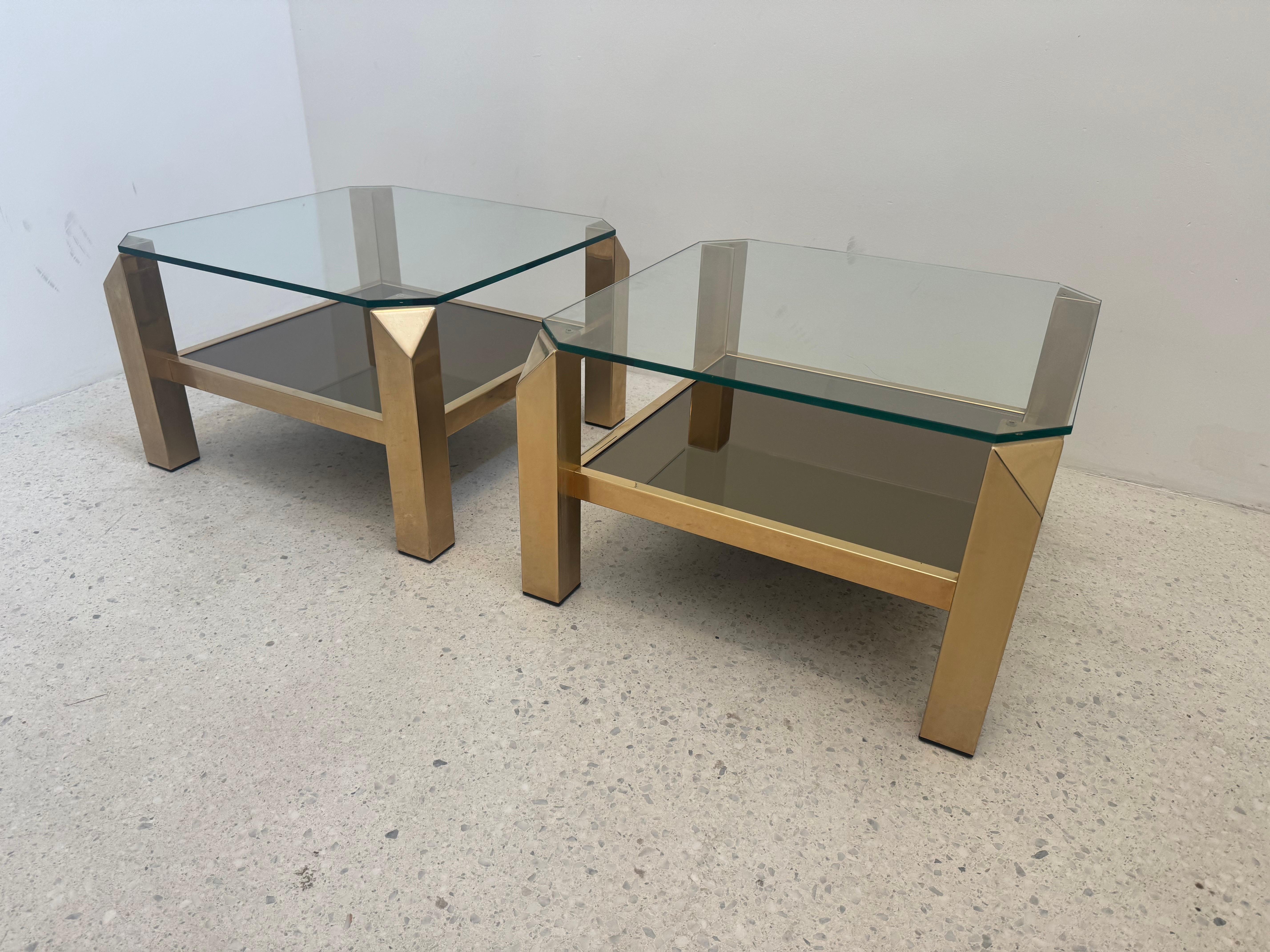 This sophisticated pair of side tables by Belgo Chrom, dating to the 1970s, showcases the brand’s hallmark combination of luxurious materials and sharp geometric forms. Each table features a 23-carat gold-plated steel frame, supporting a clear glass