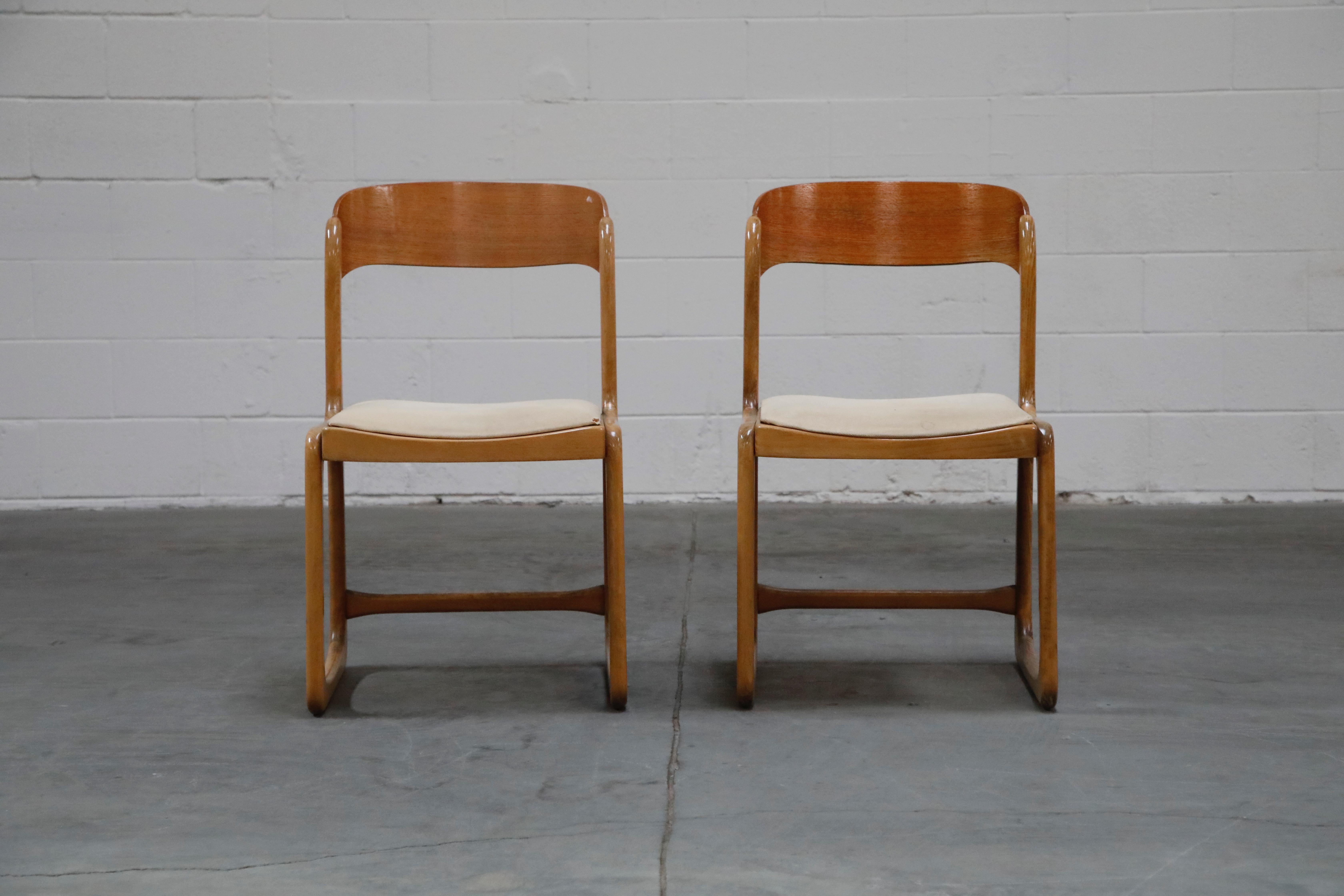 A lovely pair of side chairs and ottoman but Baumann France, circa 1970s. This bentwood Moller styled chairs feature a curved bentwood seat back, upholstered seats for the chairs and caned seat on the ottoman which also works as a low stool.  Signed