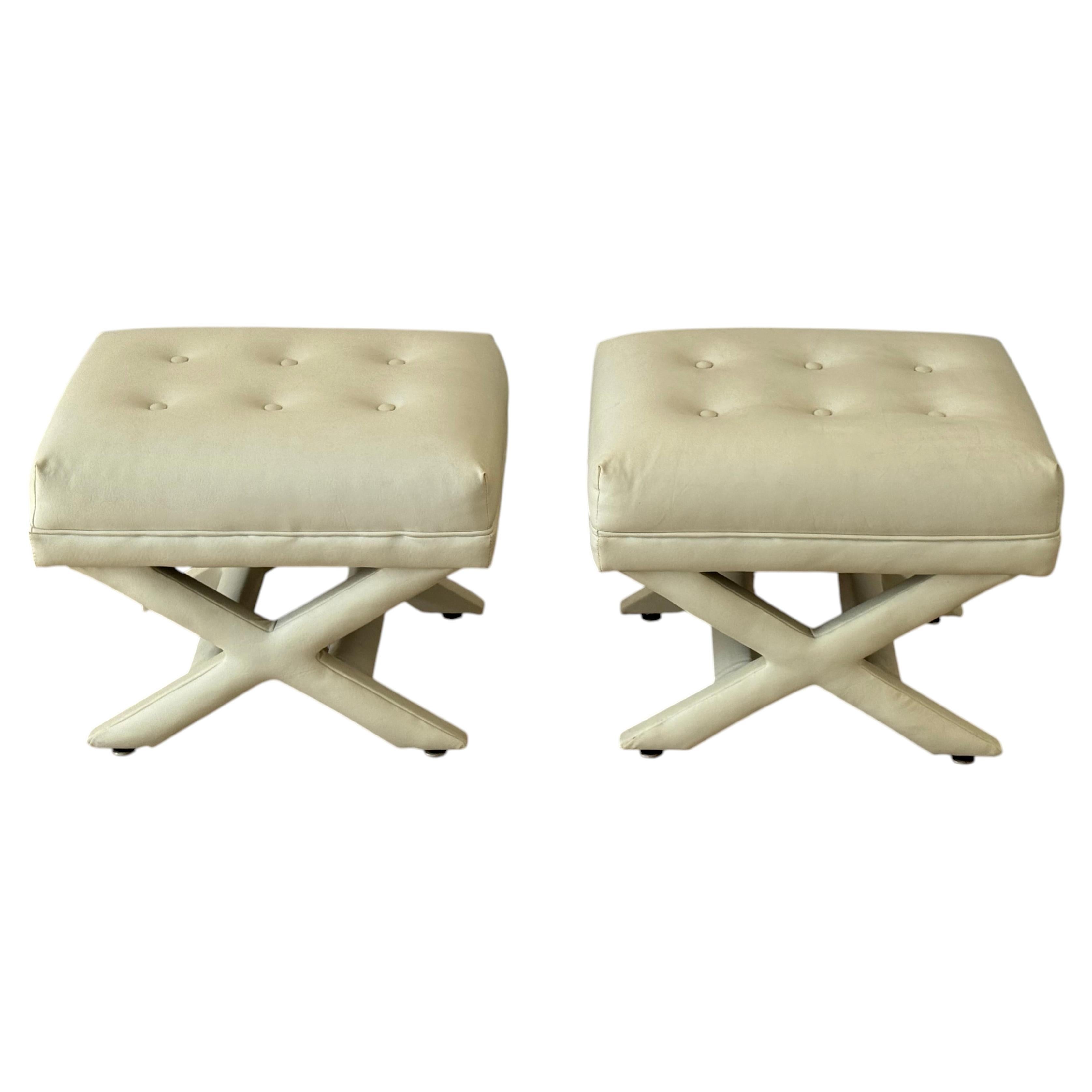 Pair of 1970s Billy Baldwin Style Creme Vinyl Upholstered X Stools or Ottomans For Sale