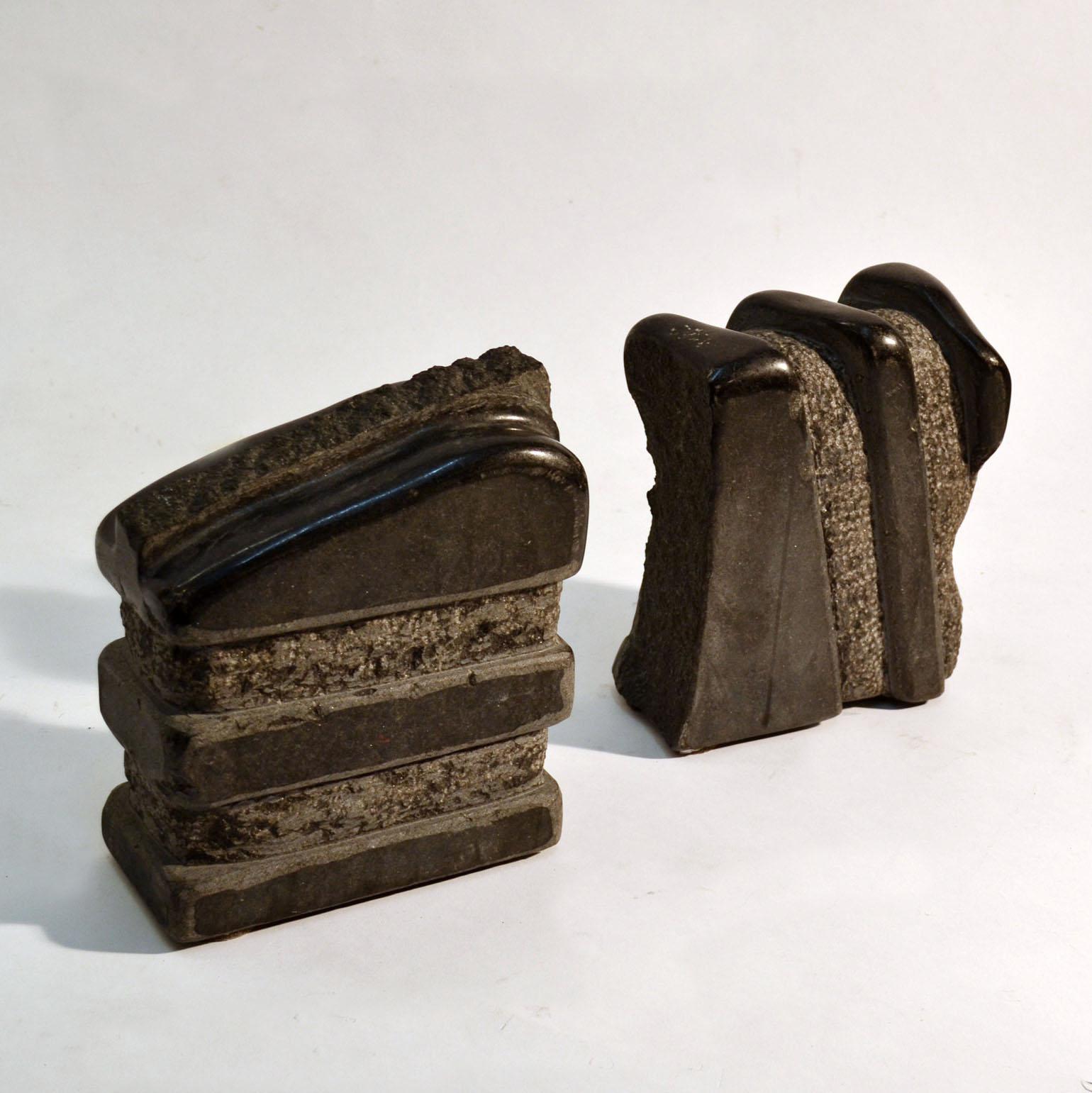 Two abstract hand-carved sculptures by the Dutch artist J. Metaho made in the 1970's. They are both composed in alternating sections of contrasting polished and textured stone. Sculpture No. 5 has a horizontal composition and No. 7 is based on a
