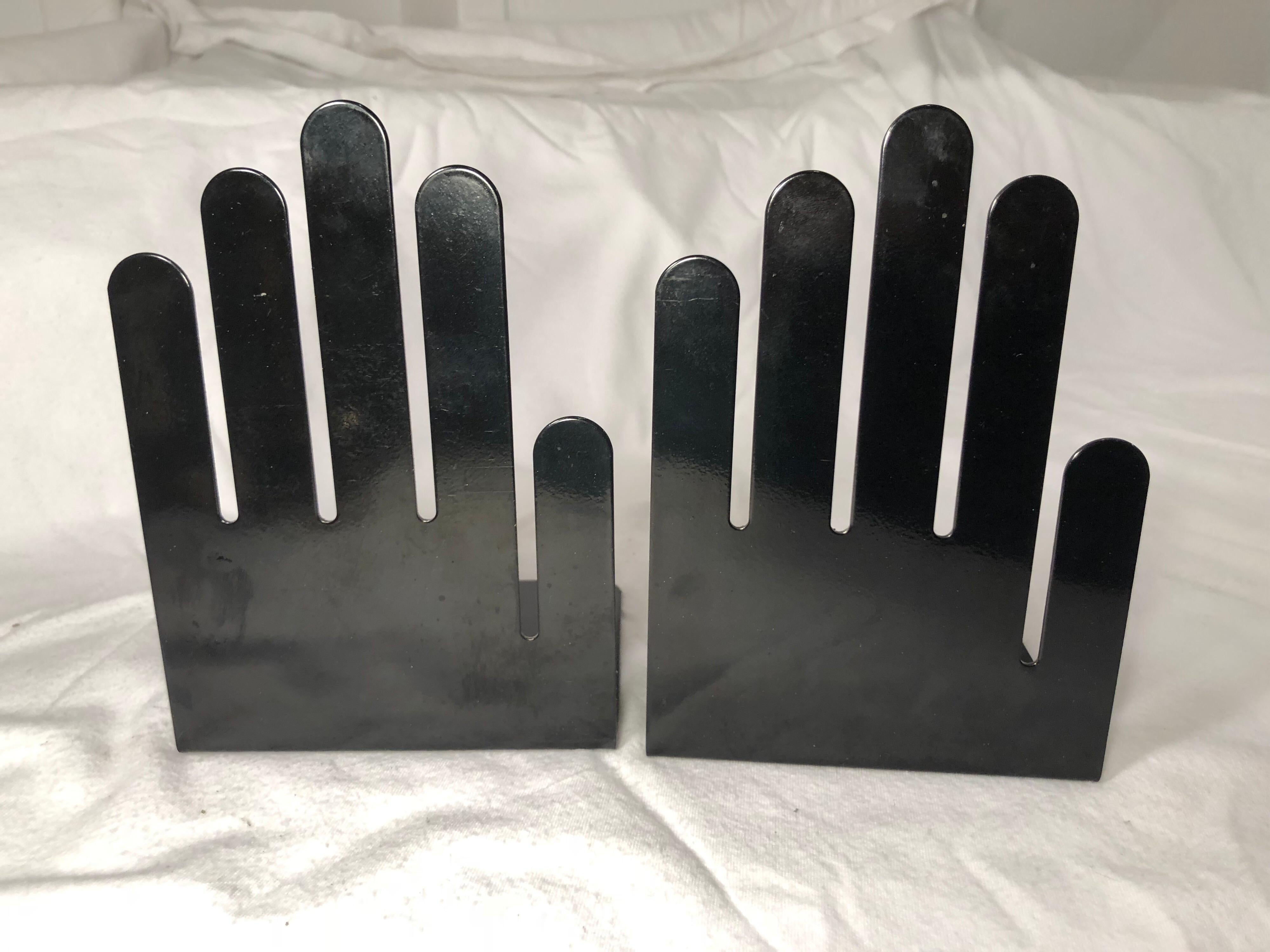 Pair of 1970s black metal hand bookends. Signed Spectrum Division Designs. Black metal hands to hold books, napkins or papers. Great Minimalist design.