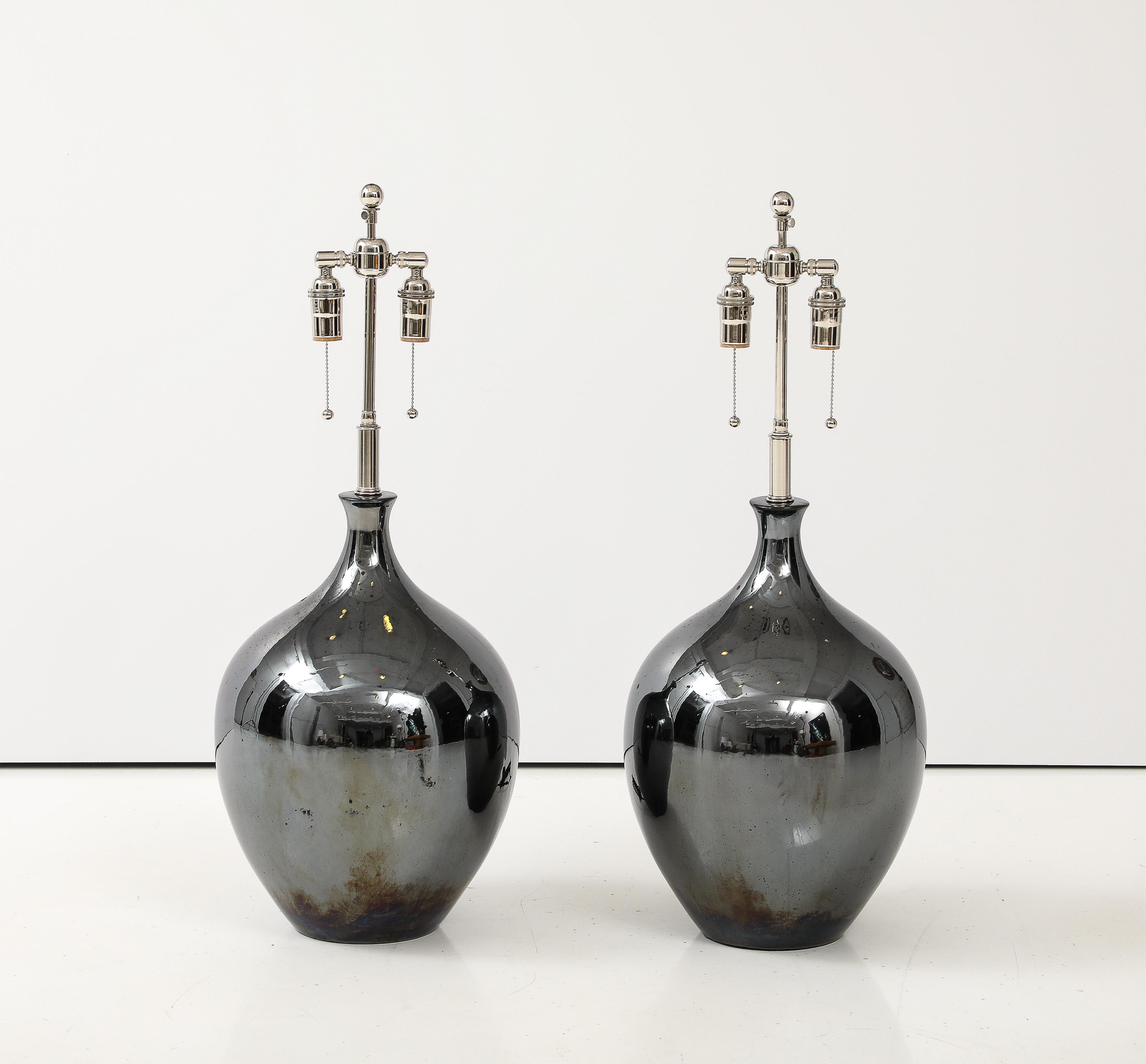 Wonderful pair of 1970's Black Nickel glazed ceramic lamps 
that have been Newly rewired with adjustable Nickel double clusters
that take standard size light bulbs and silk rayon cords.
