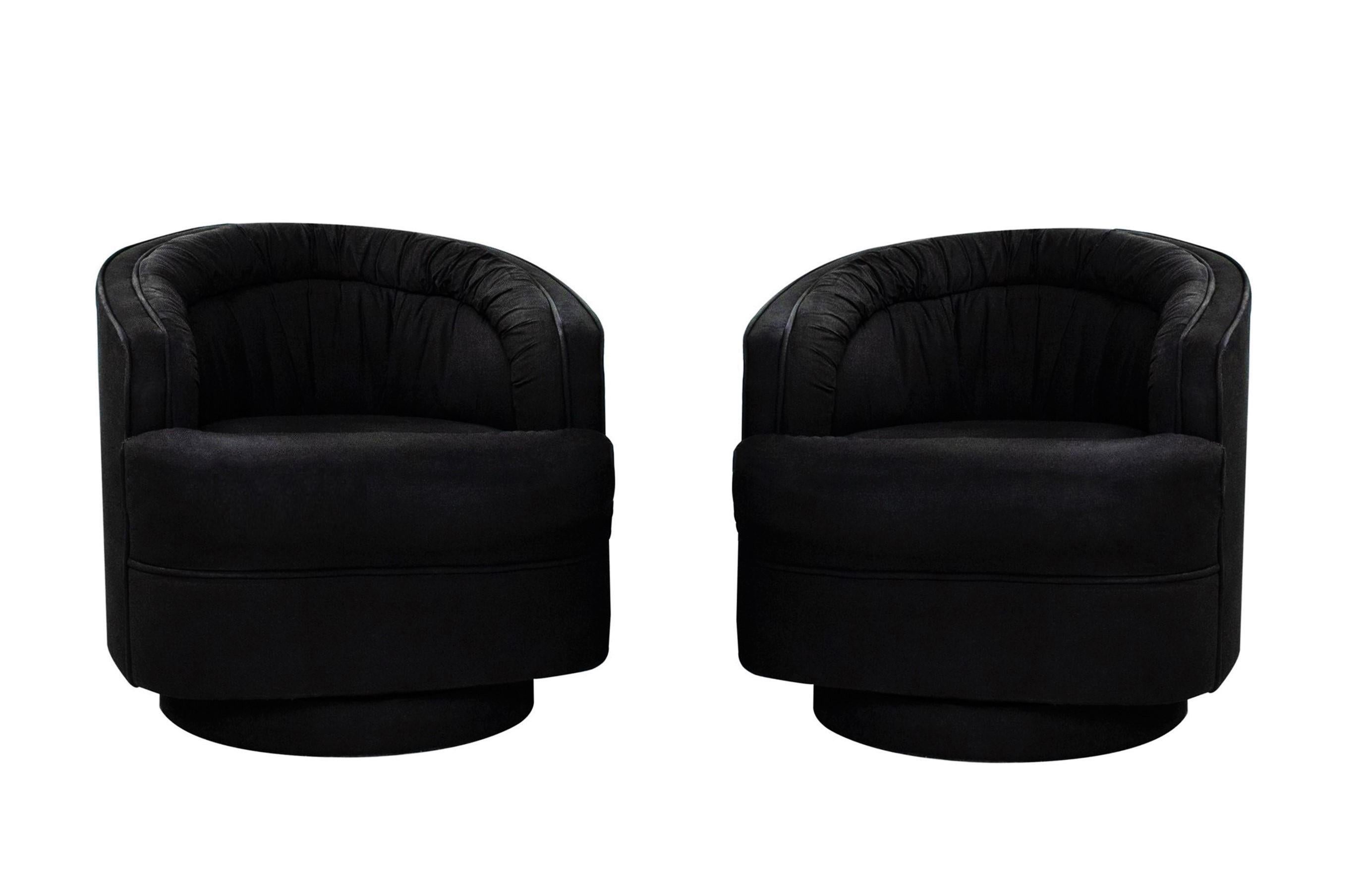 Stunning pair of ultra luxe and comfortable swivel chairs in the style of Milo Baughman. Chairs are freshly upholstered in a soft black fabric, featuring a ruched tufting or pleated back resting on upholstered bases, adds visual interest to the