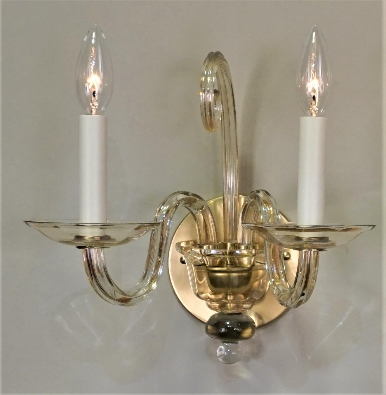 Pair of double arm champagne color hand blown glass wall sconces.